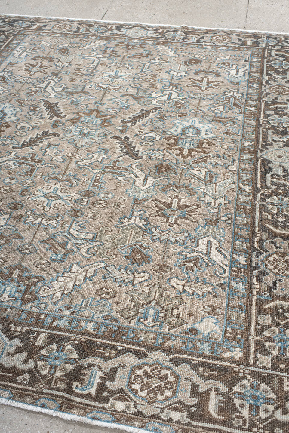 6' x 7' one-of-a-kind handmade antique Heriz rug. Color palette: taupe, brown, ivory, sky blue, charcoal, camel, beige, gray