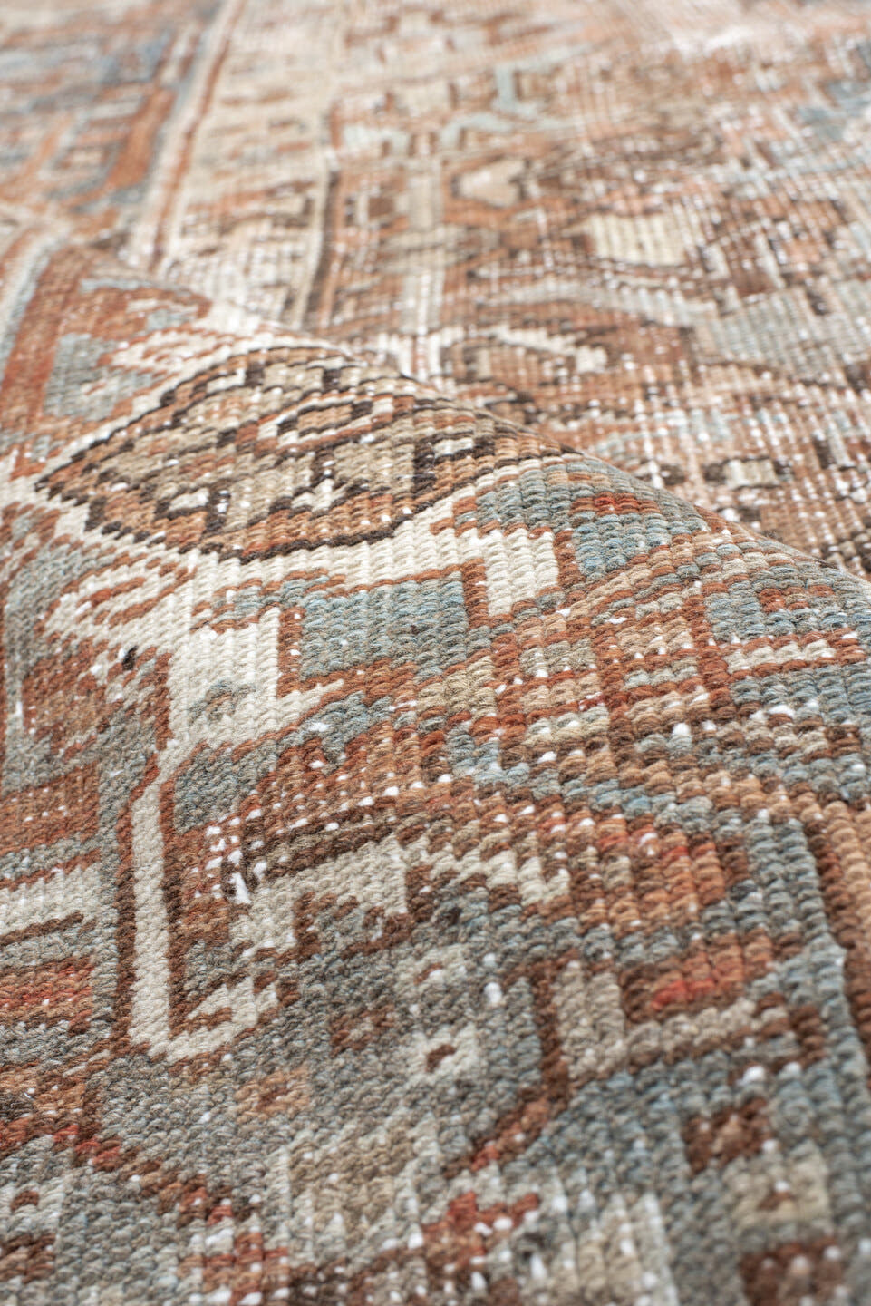 6' x 8' one-of-a-kind handmade antique Heriz medium size rug. Color palette: terra cotta, ivory, soft blue, taupe, rust