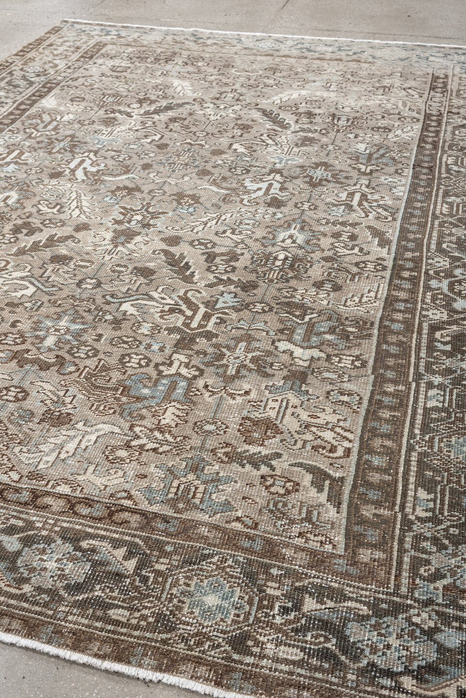 7' x 9' one-of-a-kind handmade vintage Heriz rug. Color palette: taupe, brown, ivory, pale blue, camel, charcoal, beige