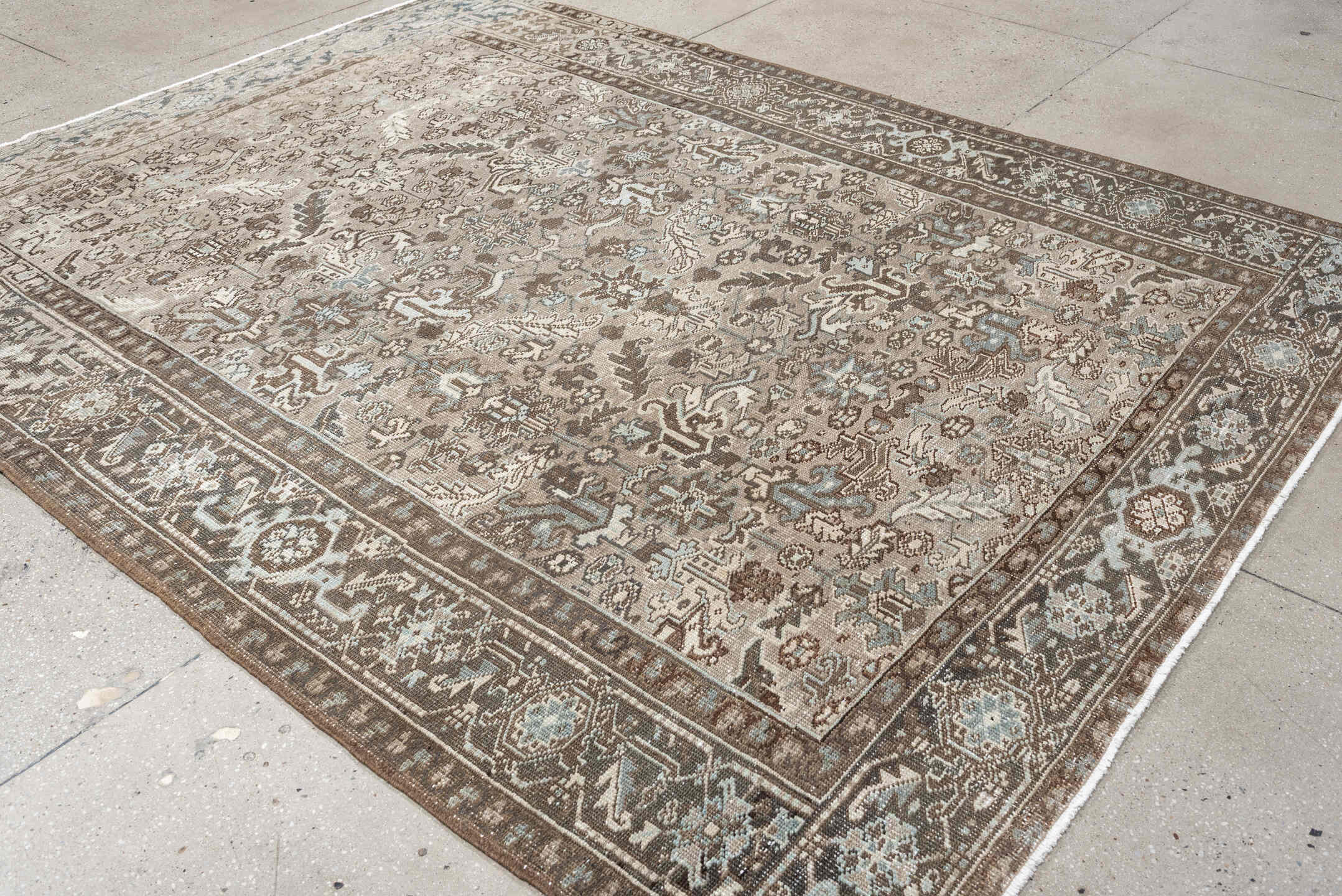 7' x 9' one-of-a-kind handmade vintage Heriz rug. Color palette: taupe, brown, ivory, pale blue, camel, charcoal, beige