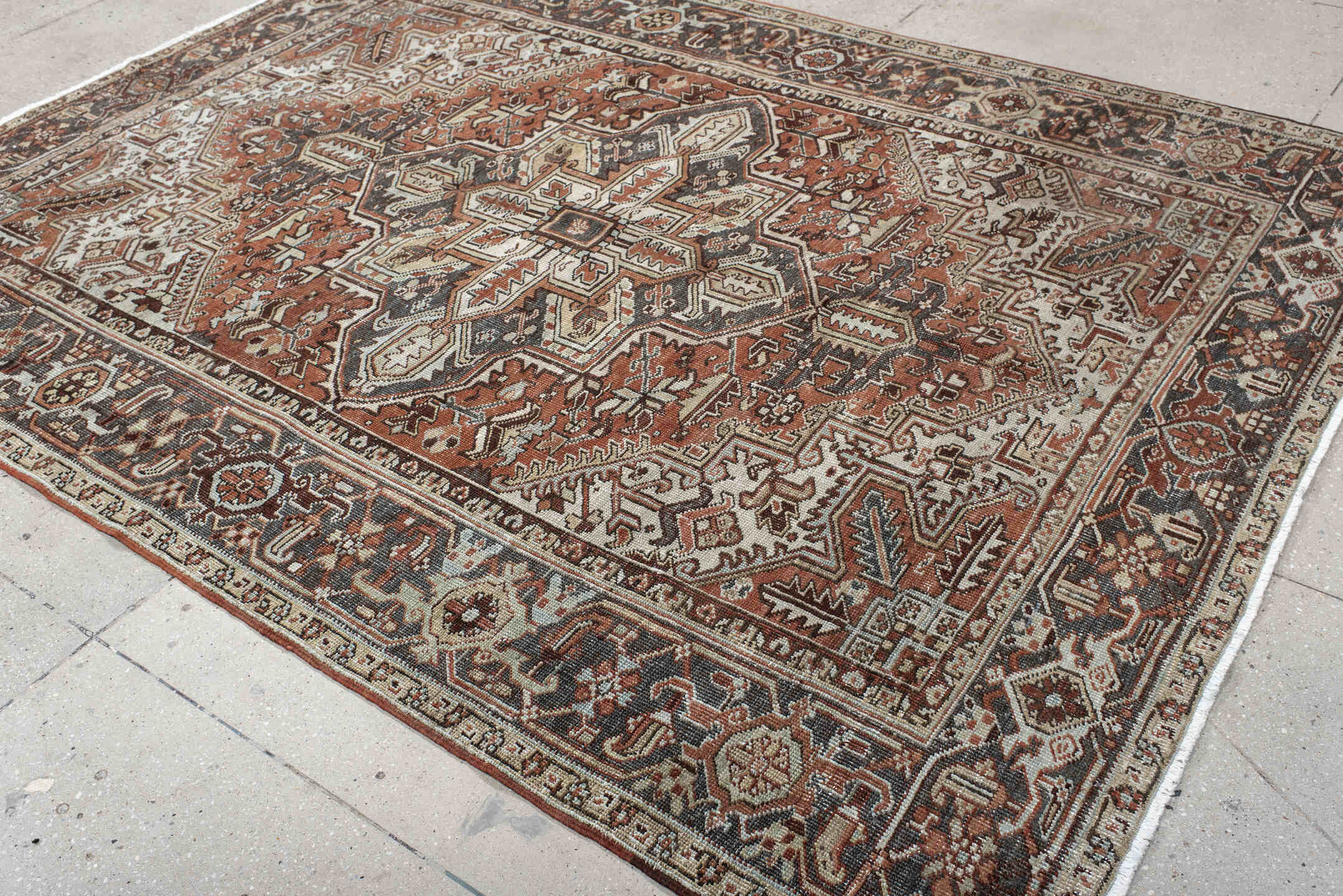 6' x 9' one-of-a-kind handmade antique Heriz medium size rug. Color palette: rust, ivory, navy, charcoal, camel, terra cotta