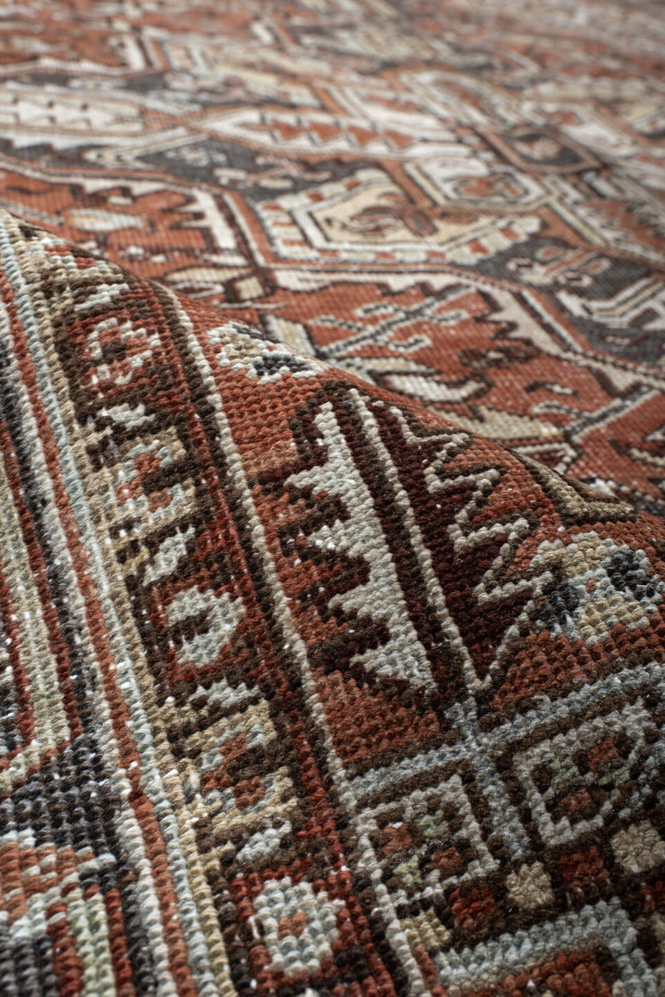 6' x 9' one-of-a-kind handmade antique Heriz medium size rug. Color palette: rust, ivory, navy, charcoal, camel, terra cotta