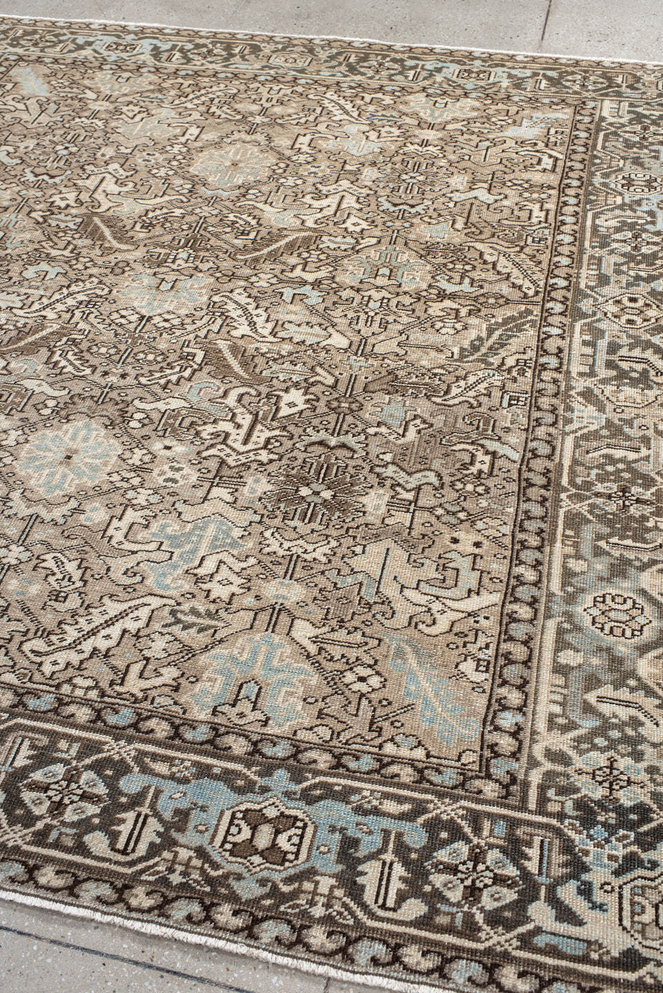 7' x 8' one-of-a-kind handmade antique Heriz rug. Color palette: ivory, taupe, brown, camel, pale blue, charcoal, beige