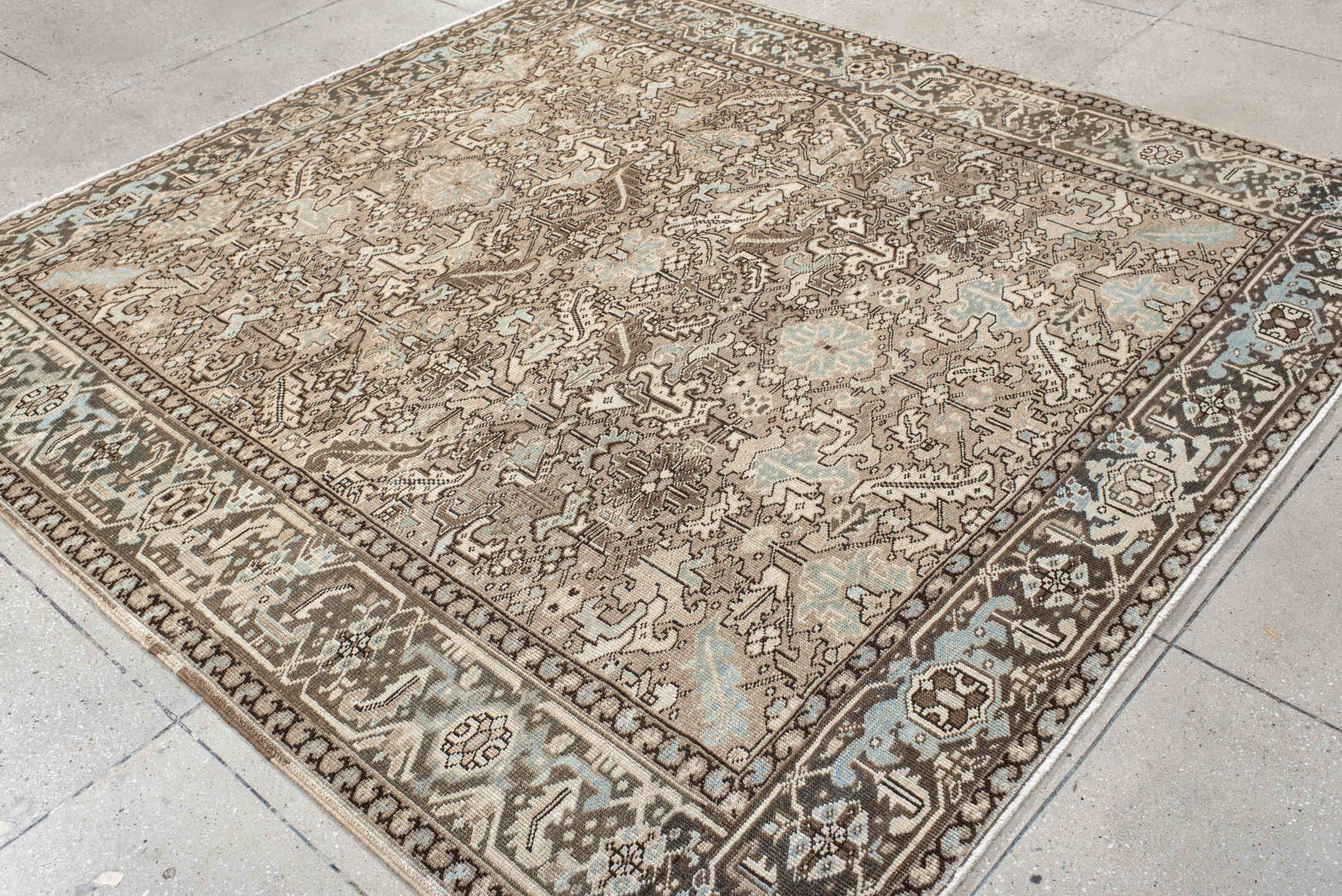 7' x 8' one-of-a-kind handmade antique Heriz rug. Color palette: ivory, taupe, brown, camel, pale blue, charcoal, beige