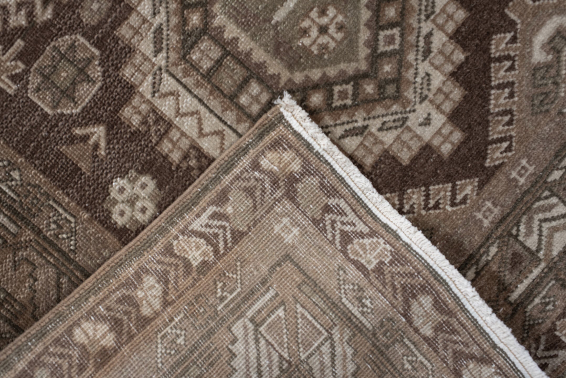 2' x 10' one-of-a-kind handmade vintage Sivas runner rug. Color palette: brown, gray, light gray, off-white, pink