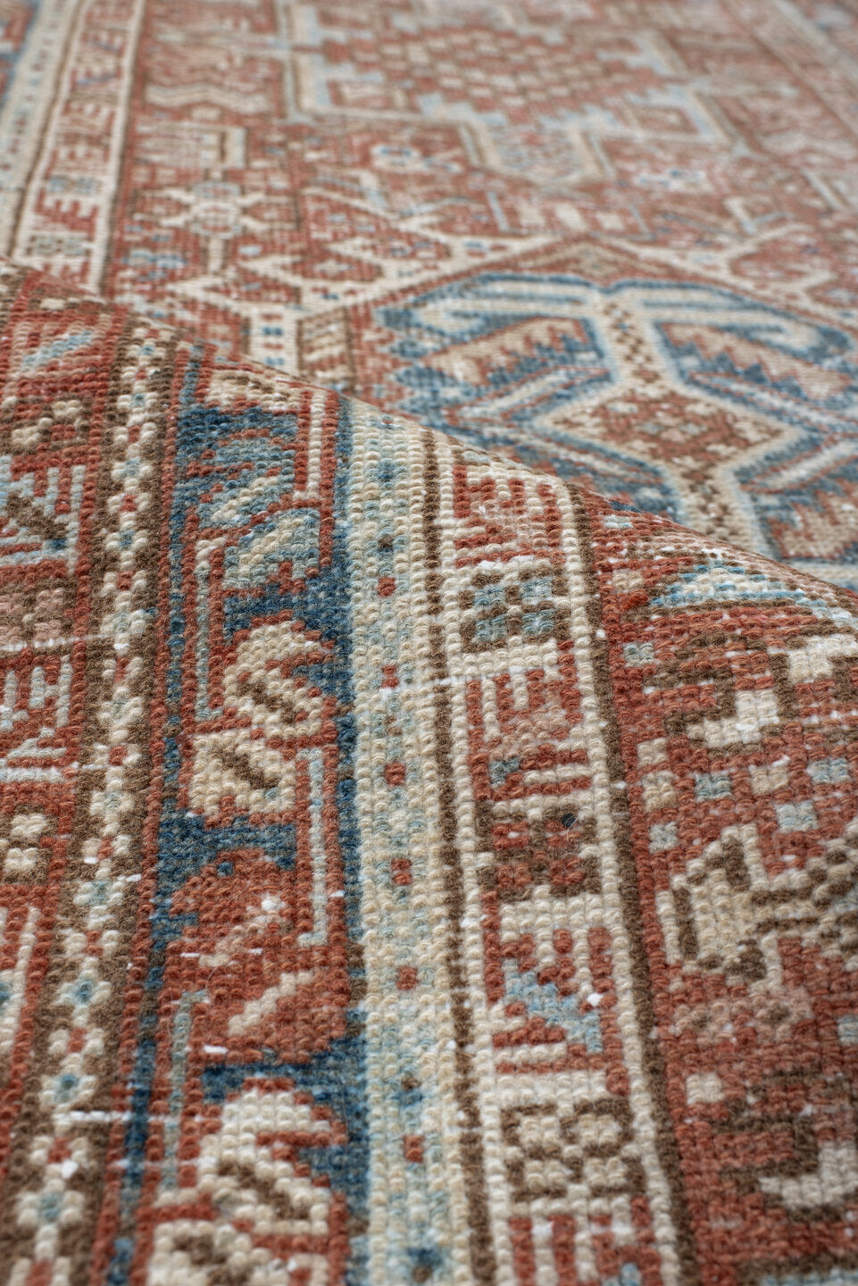 3' x 11' one-of-a-kind handmade antique Karaje runner rug. Color palette: terra cotta, ivory, sky blue, rust, camel, slate
