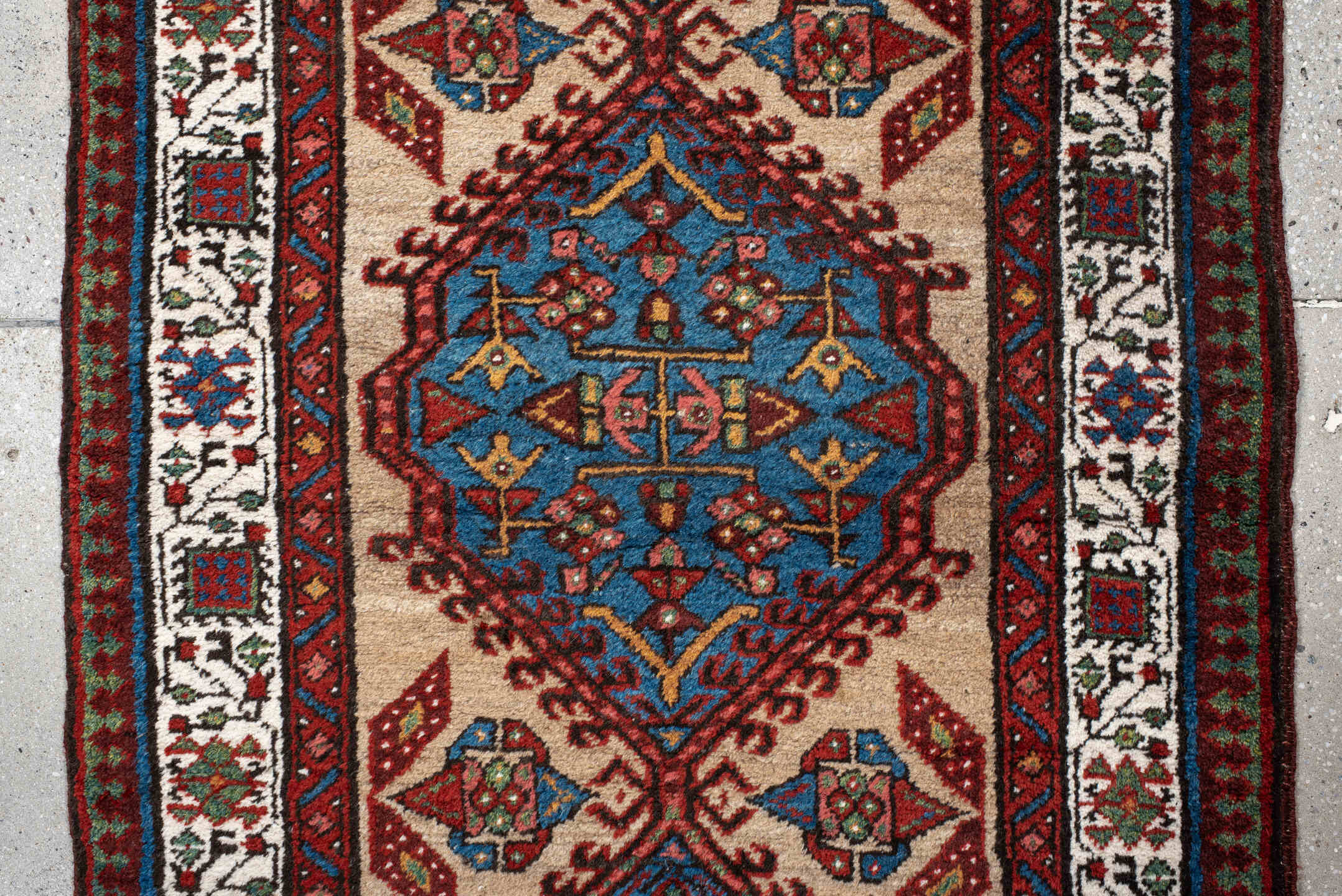 3' x 10' one-of-a-kind handmade antique Sarab runner rug. Color palette: ivory, rust, sky blue, crimson, navy, teal, brown