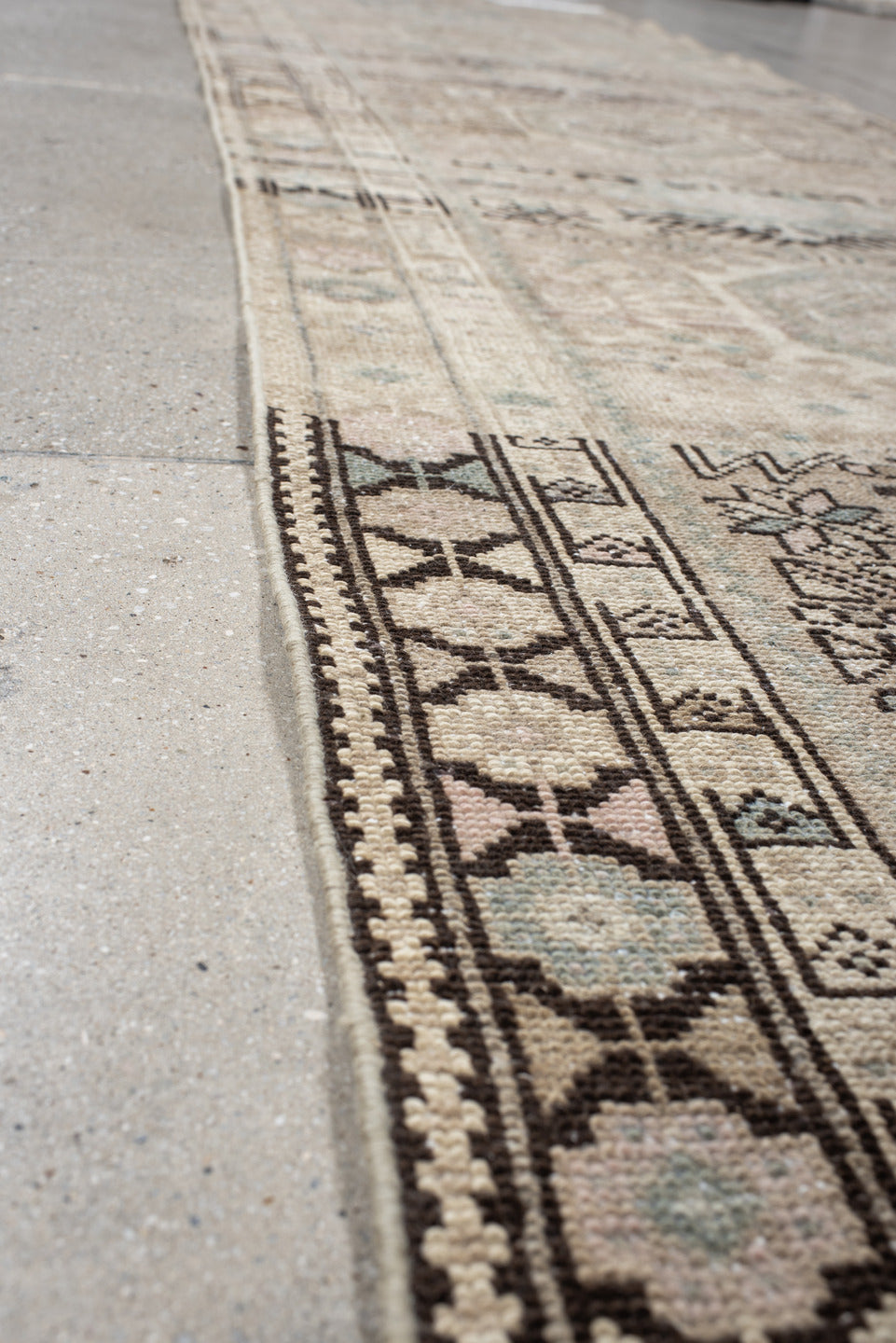 3' x 12' one-of-a-kind handmade vintage Karaje runner rug. Color palette: black, dim gray, gray, light gray, off-white, pink