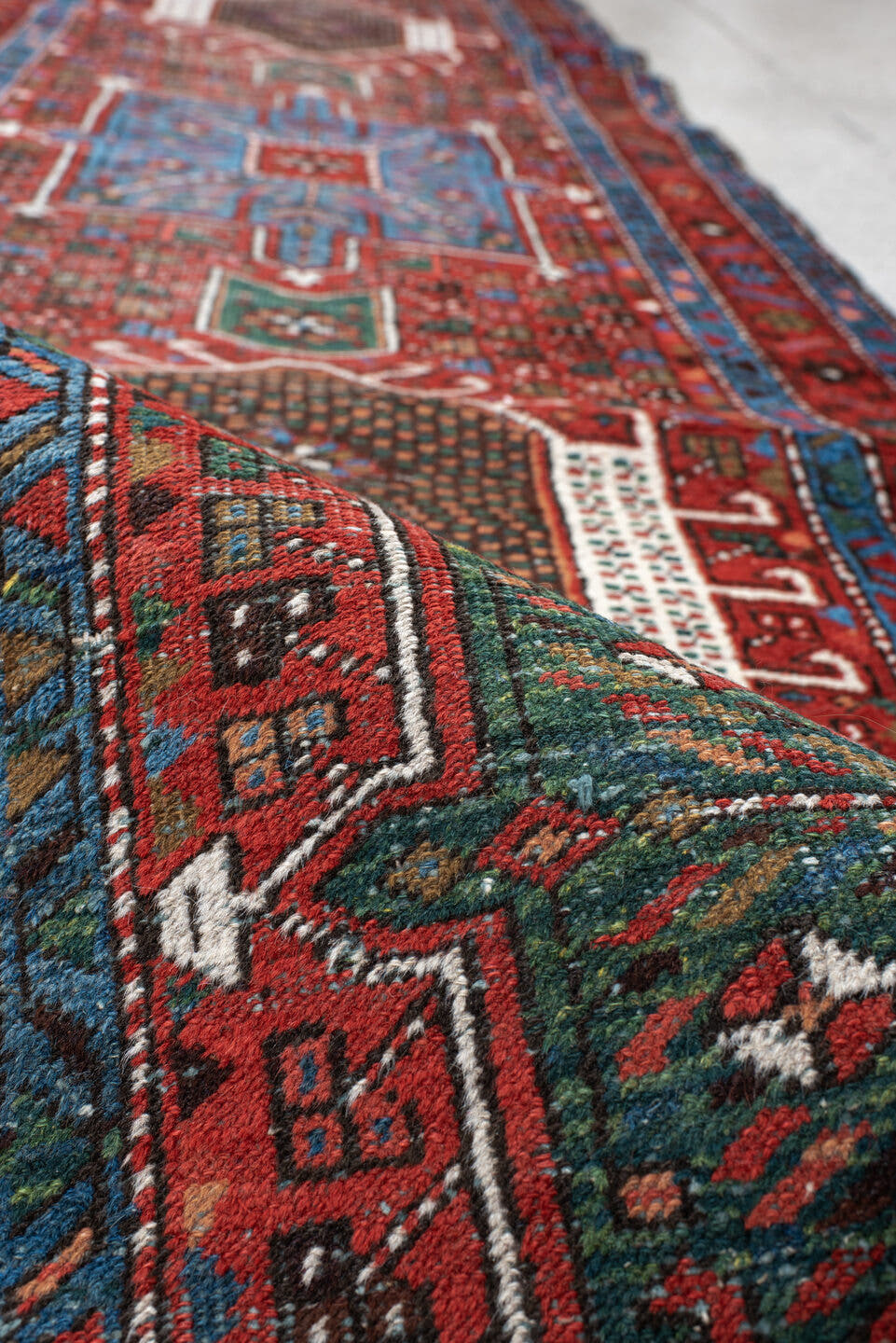 2' x 10' one-of-a-kind handmade antique Karaje runner rug. Color palette: rust, sky blue, ivory, teal, crimson, charcoal