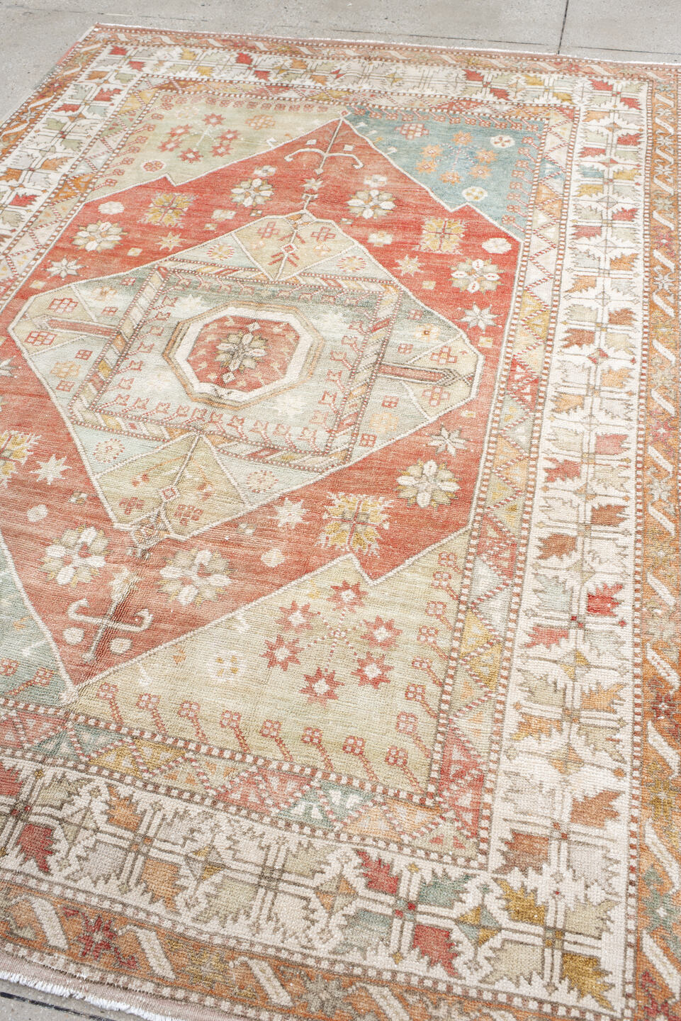6' x 9' one-of-a-kind handmade antique Anatolian medium size rug. Color palette: ivory, coral, sage, pale_blue, taupe, gold