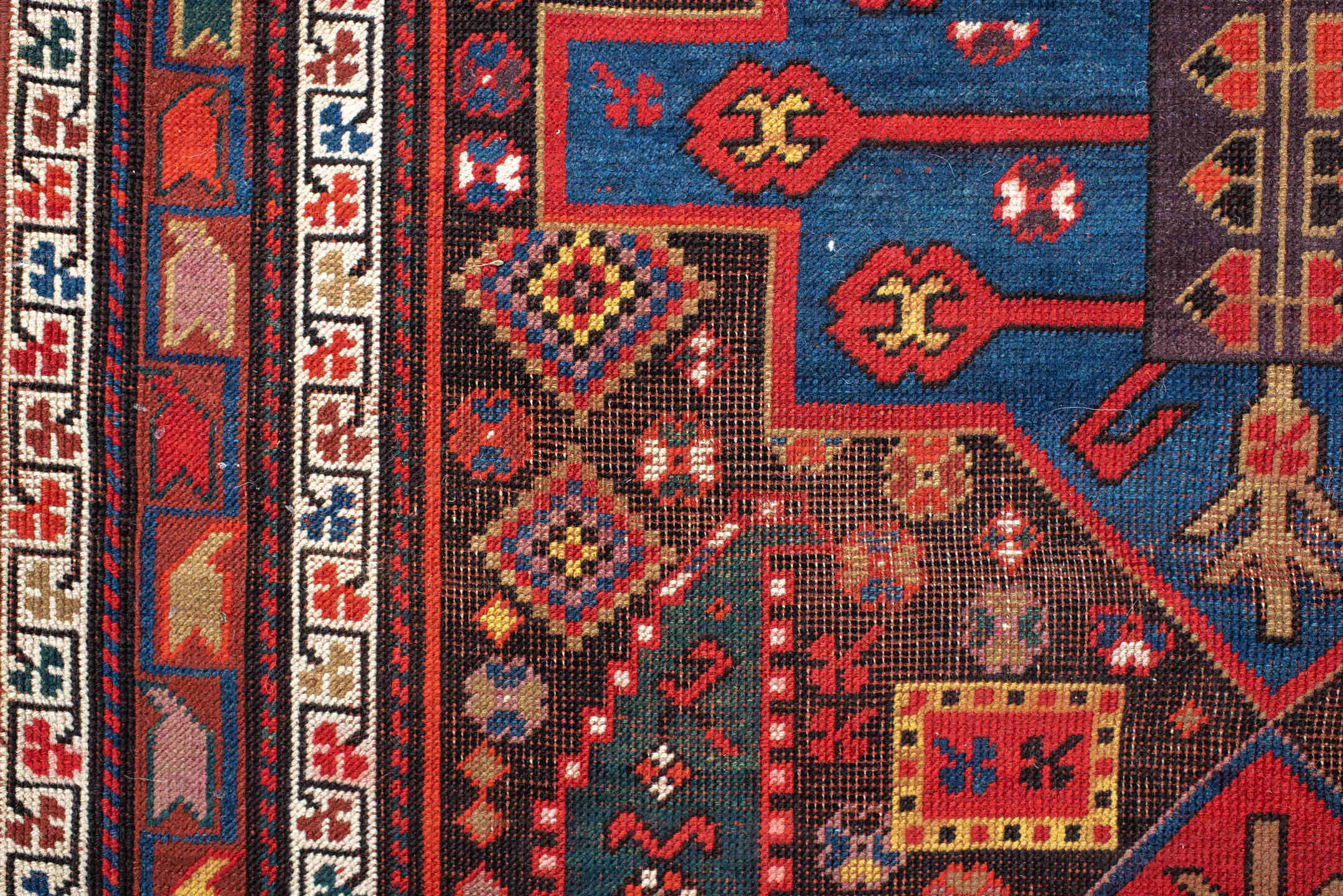 3' x 8' one-of-a-kind handmade antique Caucasian runner rug. Color palette: rust, ivory, navy, indigo, camel, crimson