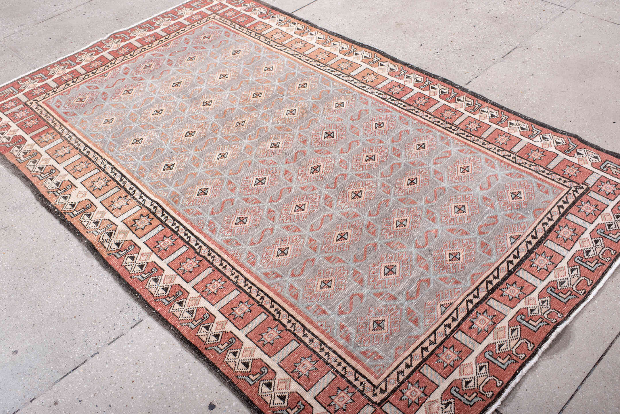 4' x 7' one-of-a-kind handmade vintage Sparta rug. Color palette: black, brown, gray, light gray, off-white, pink, red
