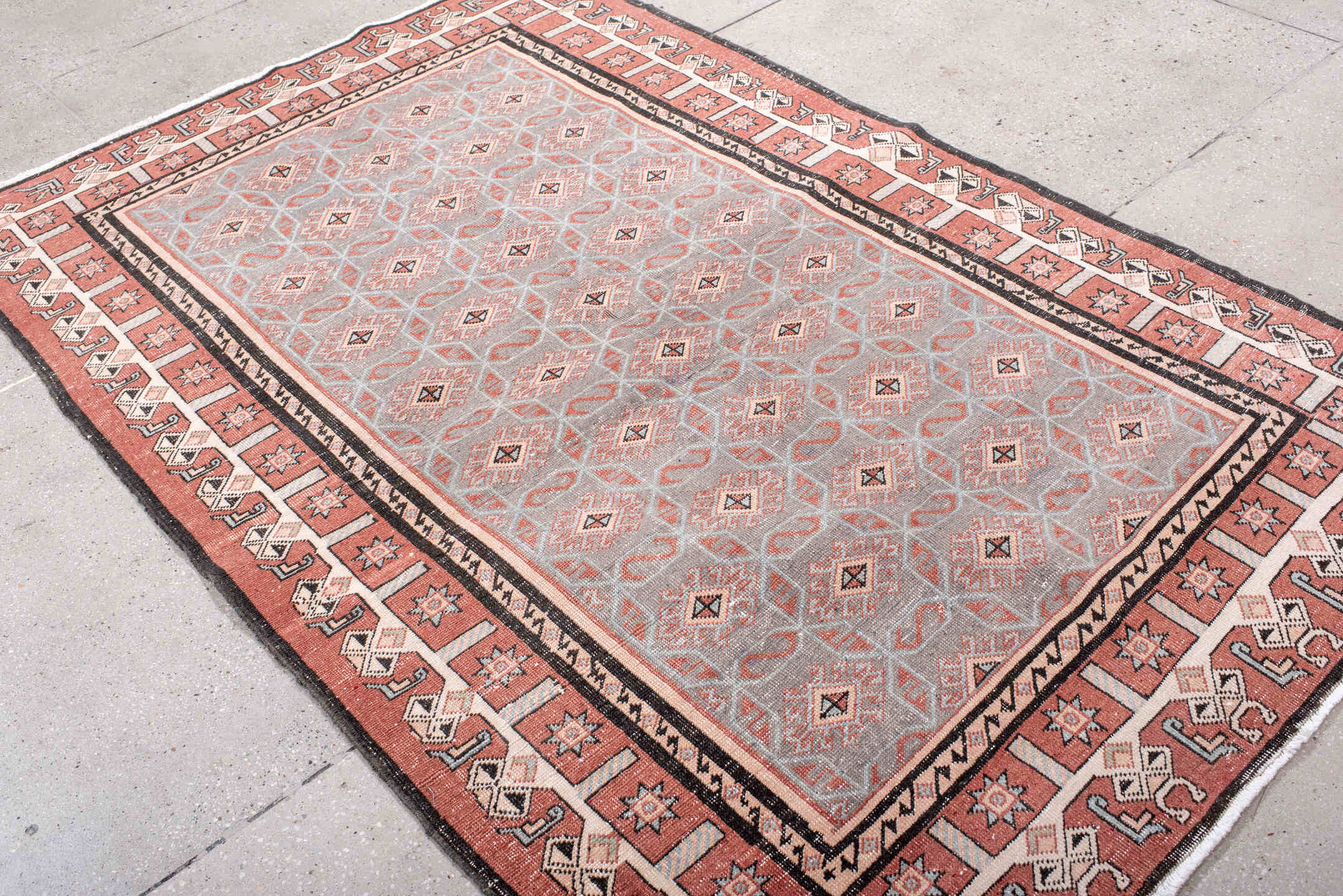 4' x 7' one-of-a-kind handmade vintage Sparta rug. Color palette: black, brown, gray, light gray, off-white, pink, red