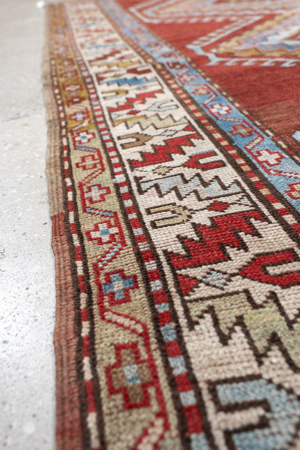 4' x 7' one-of-a-kind handmade vintage Kazak rug. Color palette: rust, ivory, sky blue, brick red, camel, taupe, gold, brown