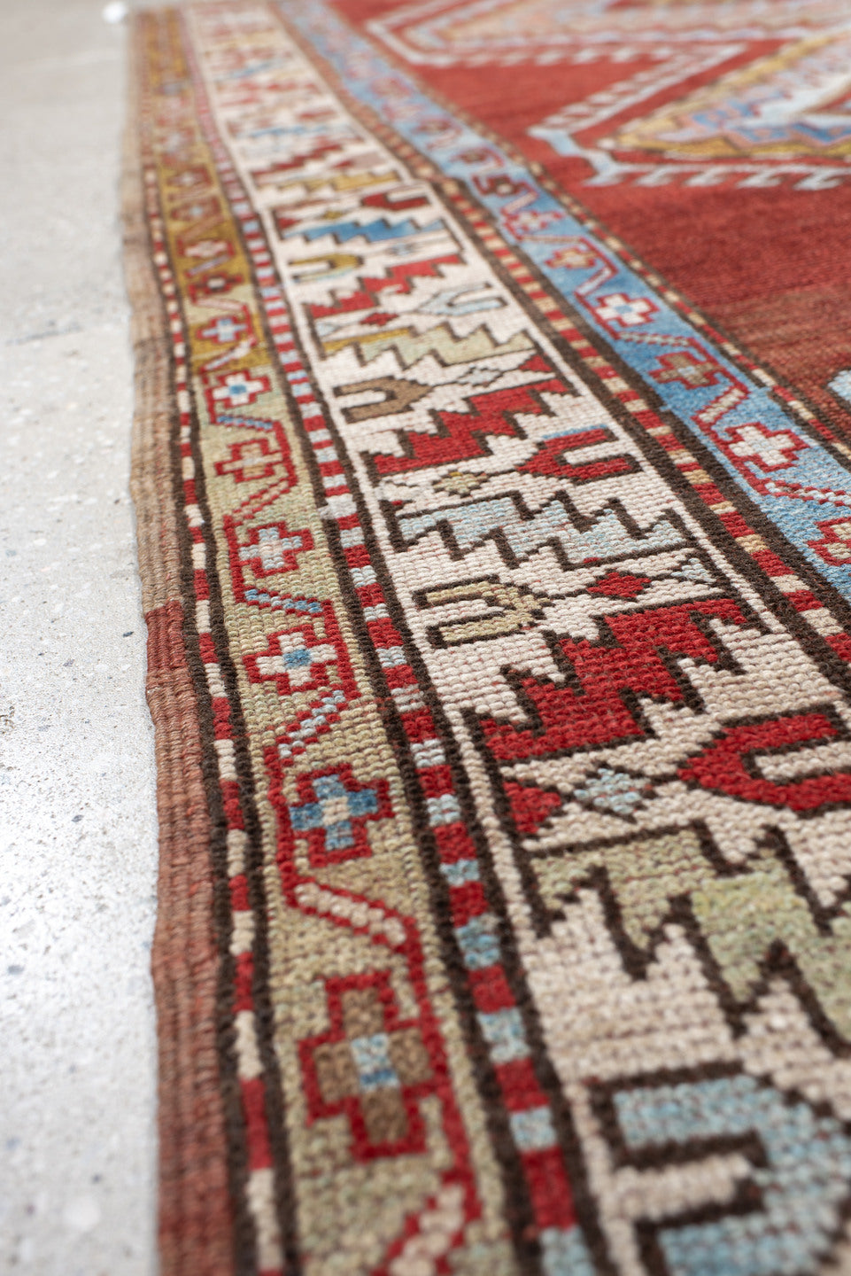 4' x 7' one-of-a-kind handmade vintage Kazak rug. Color palette: rust, ivory, sky blue, brick red, camel, taupe, gold, brown
