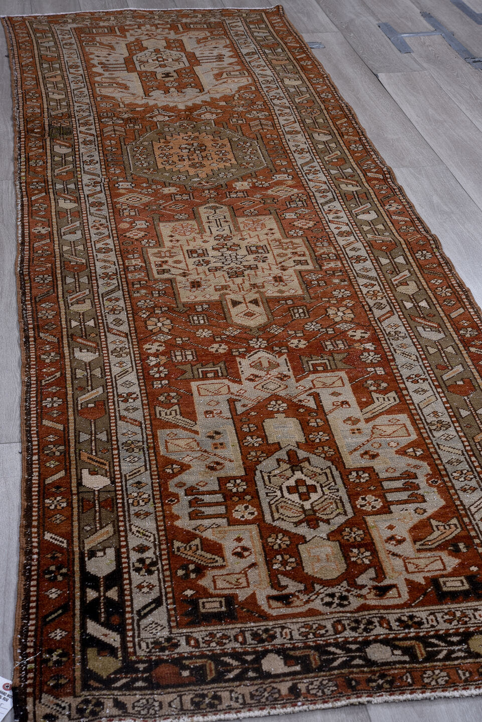 3' x 11' one-of-a-kind handmade antique Heriz runner rug. Color palette: rust, ivory, brown, taupe, charcoal, black, camel
