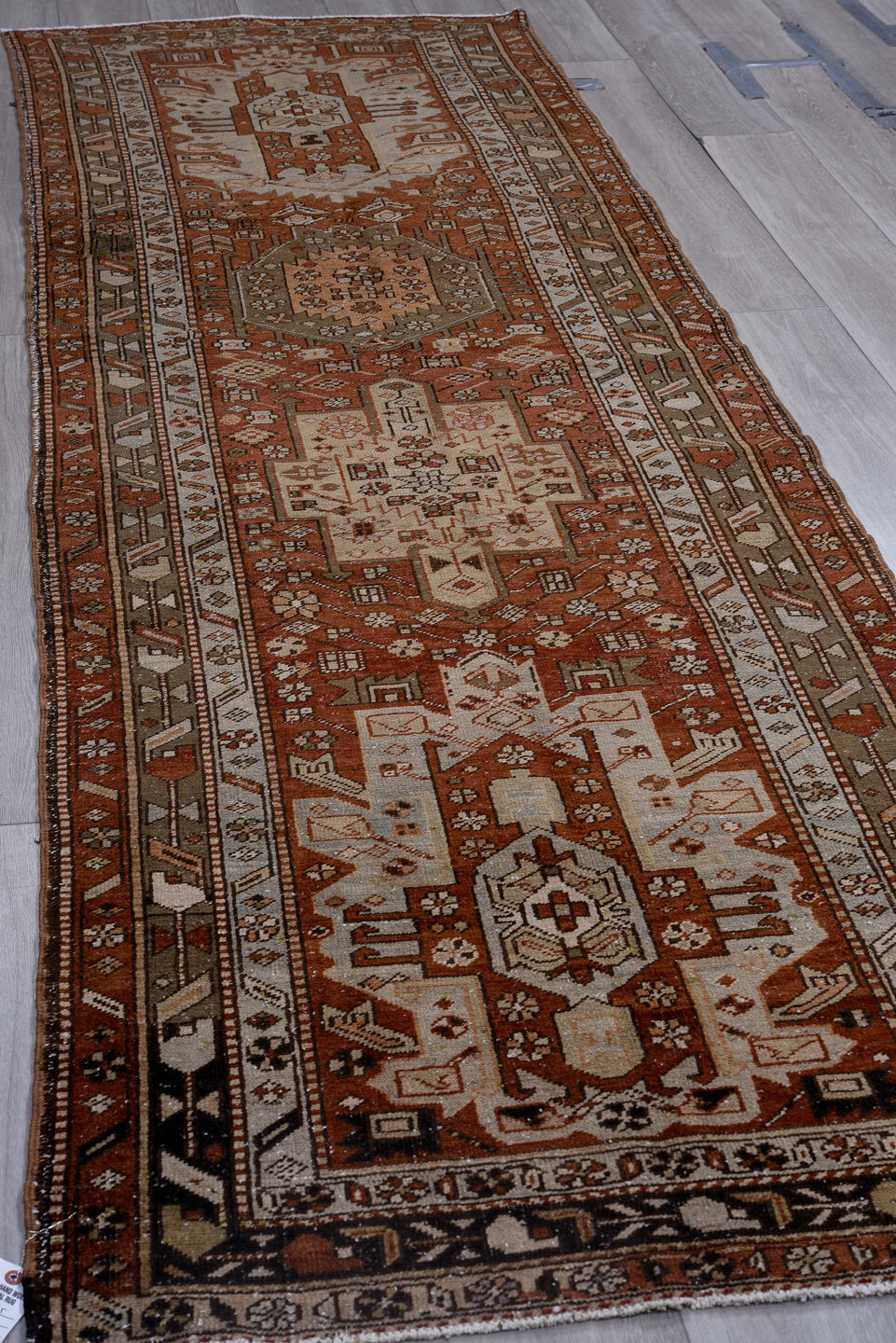 3' x 11' one-of-a-kind handmade antique Heriz runner rug. Color palette: rust, ivory, brown, taupe, charcoal, black, camel