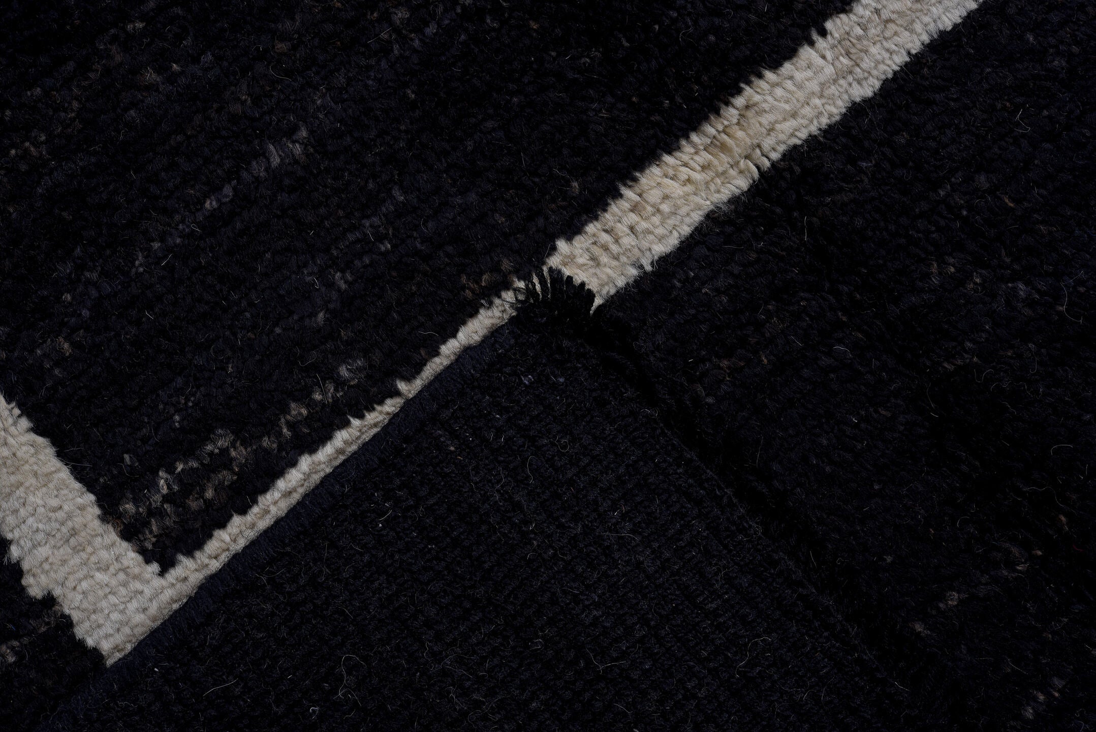 7' x 9' one-of-a-kind handmade vintage Tulu large size rug. Color palette: black, ivory