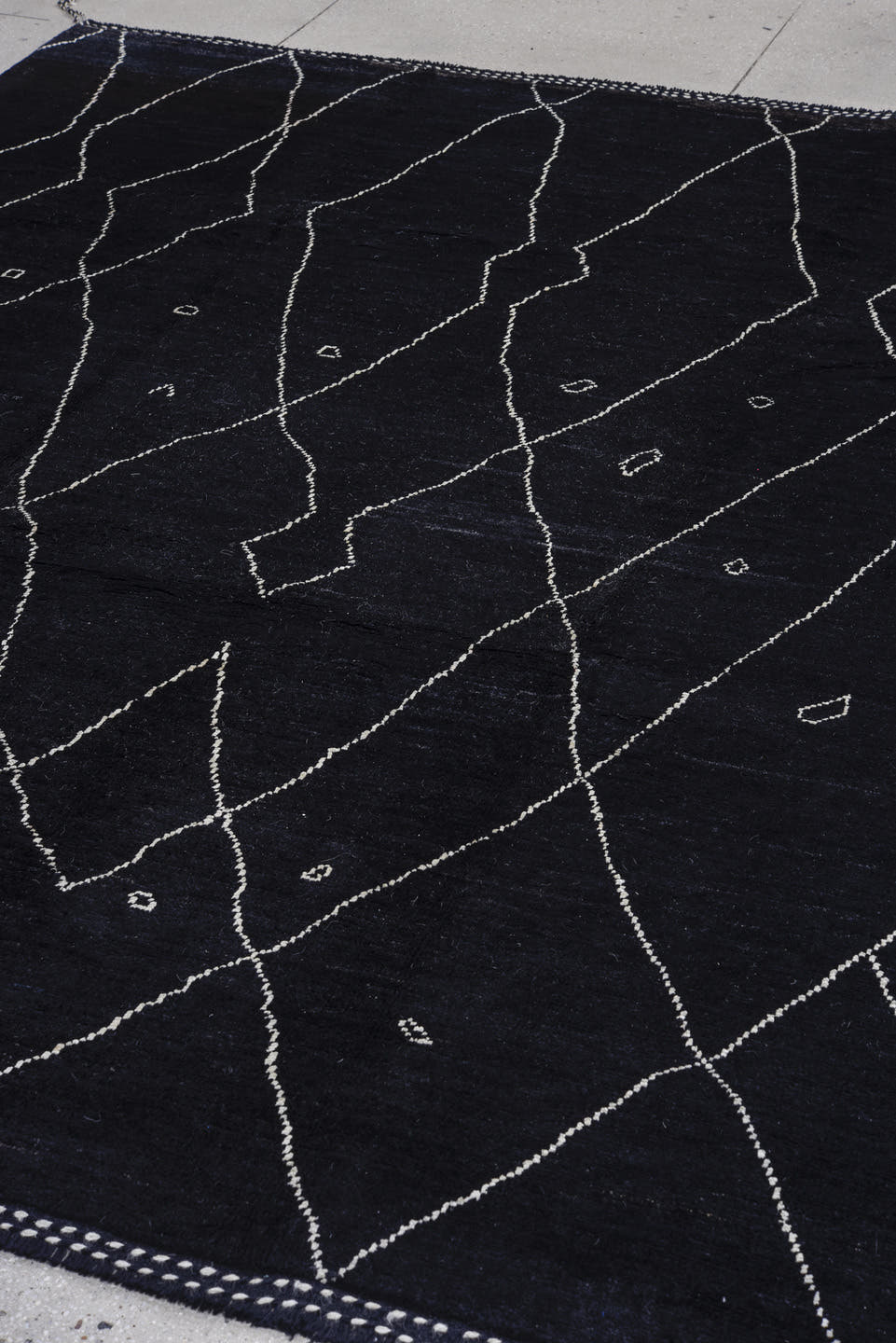 8' x 9' one-of-a-kind handmade vintage Tulu rug. Color palette: black, ivory