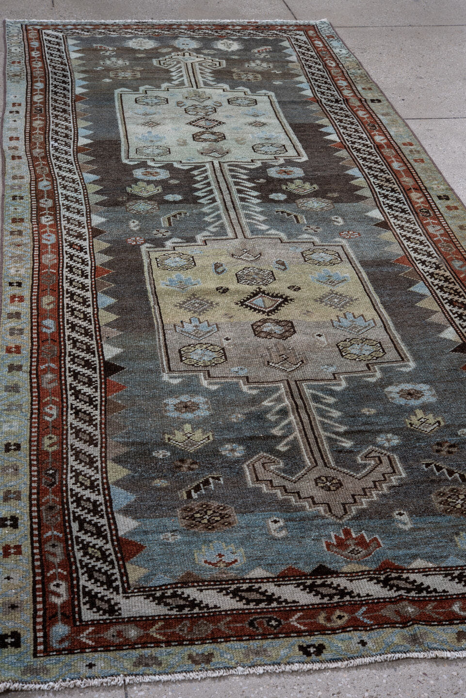 4' x 10' one-of-a-kind handmade antique Kurd runner rug. Color palette: blue, ivory, rust, charcoal, light blue, brown