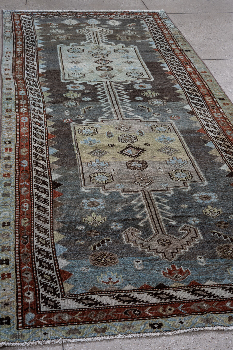 4' x 10' one-of-a-kind handmade vintage Kurd runner rug. Color palette: black, blue, brown, charcoal, dark gray, gray