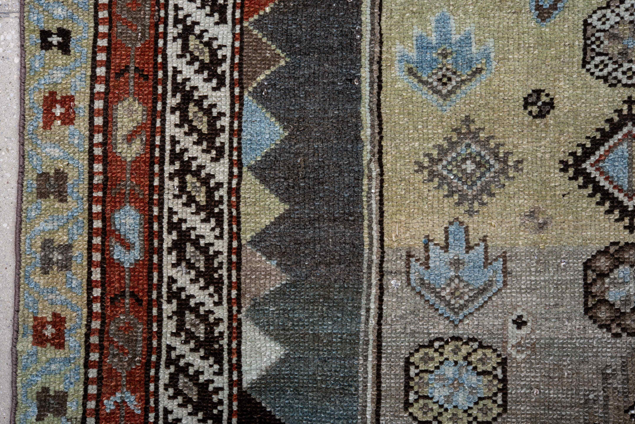 4' x 10' one-of-a-kind handmade vintage Kurd runner rug. Color palette: black, blue, brown, charcoal, dark gray, gray