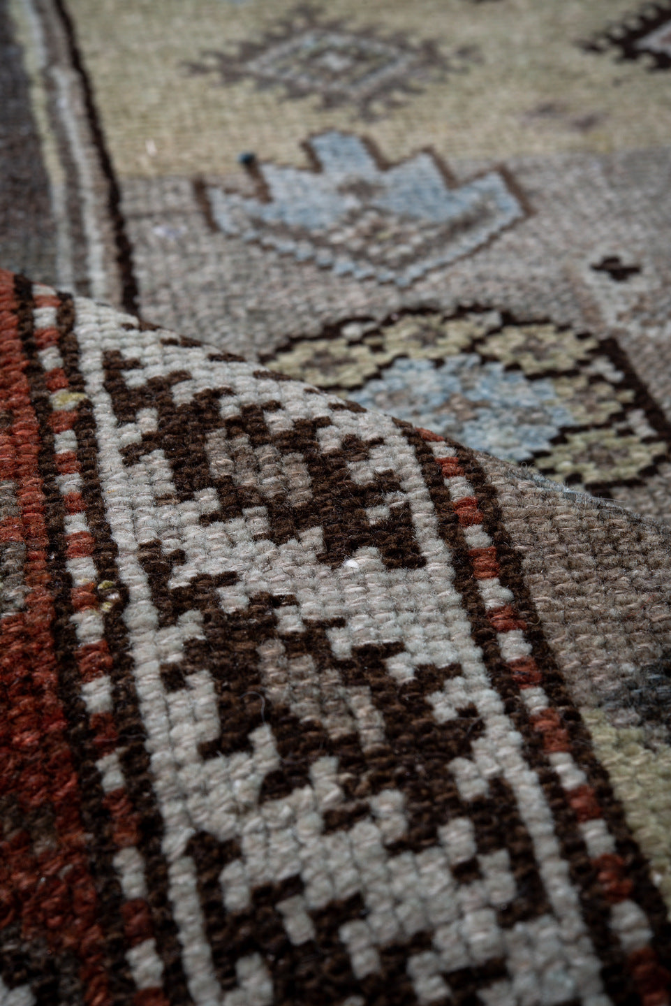 4' x 10' one-of-a-kind handmade vintage Kurd runner rug. Color palette: black, blue, brown, charcoal, dark gray, gray