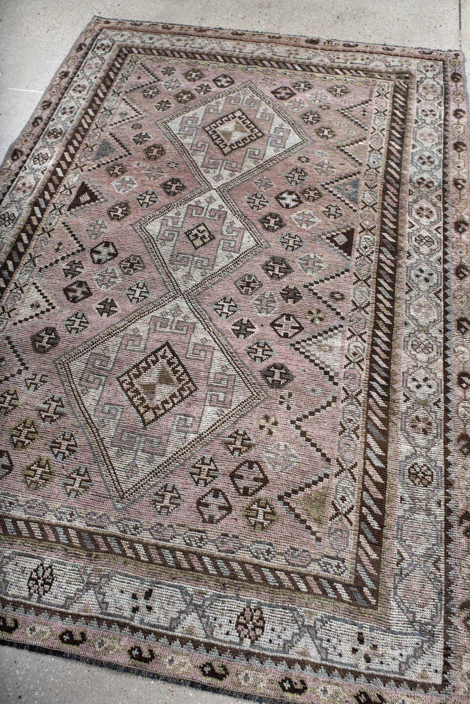 4' x 7' one-of-a-kind handmade antique Shiraz rug. Color palette: rose, ivory, brown, taupe, sage, charcoal, pink, red