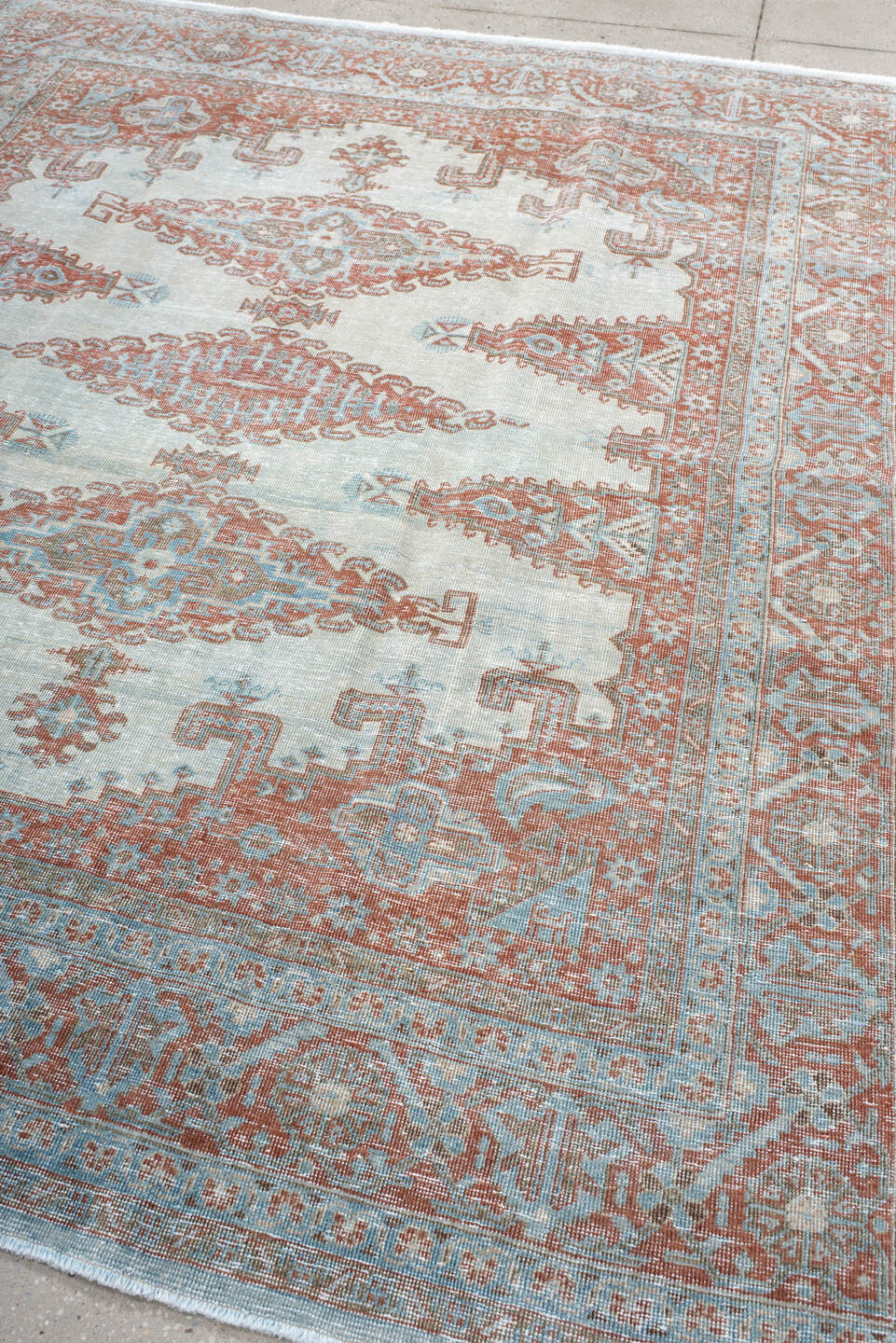 7' x 8' one-of-a-kind handmade antique Veece rug. Color palette: pale blue, rust, ivory, terracotta, sky blue, light blue
