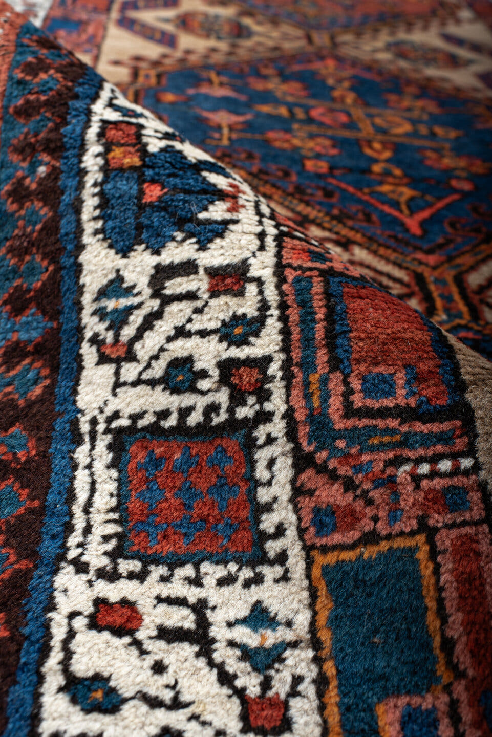 3' x 8' one-of-a-kind handmade antique Sarab runner rug. Color palette: ivory, indigo, rust, navy, terra cotta, camel