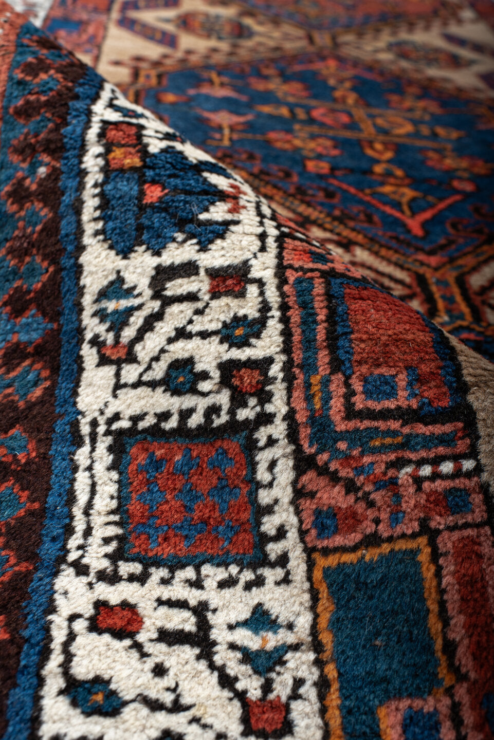 3' x 8' one-of-a-kind handmade antique Sarab runner rug. Color palette: ivory, indigo, rust, navy, terra cotta, camel
