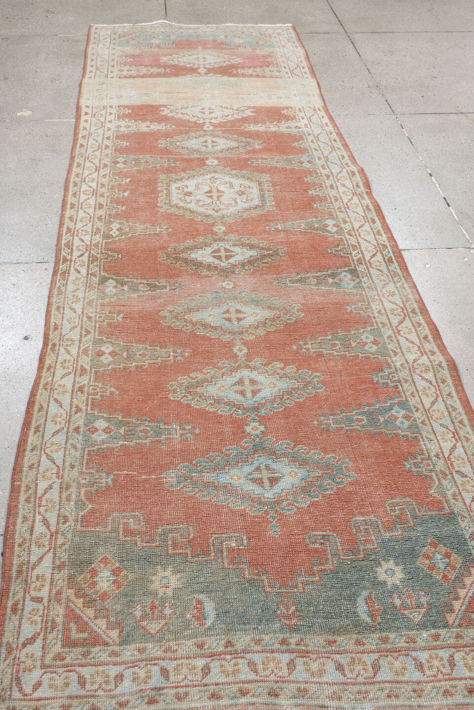 3' x 11' one-of-a-kind handmade antique Veece runner rug. Color palette: coral, ivory, pale blue, sage, cream, terra cotta