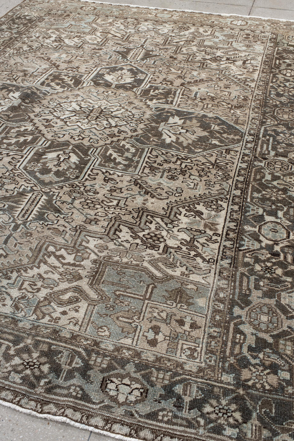 7' x 9' one-of-a-kind handmade antique Heriz large size rug. Color palette: taupe, charcoal, ivory, camel, slate, brown