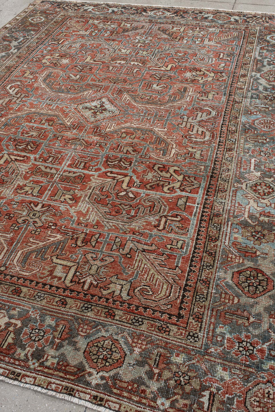 7' x 9' one-of-a-kind handmade antique Heriz large size rug. Color palette: terra cotta, ivory, slate, charcoal, rust, camel