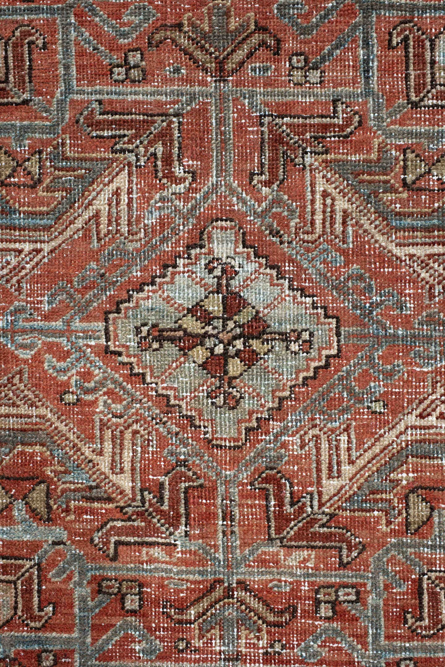 7' x 9' one-of-a-kind handmade antique Heriz large size rug. Color palette: terra cotta, ivory, slate, charcoal, rust, camel