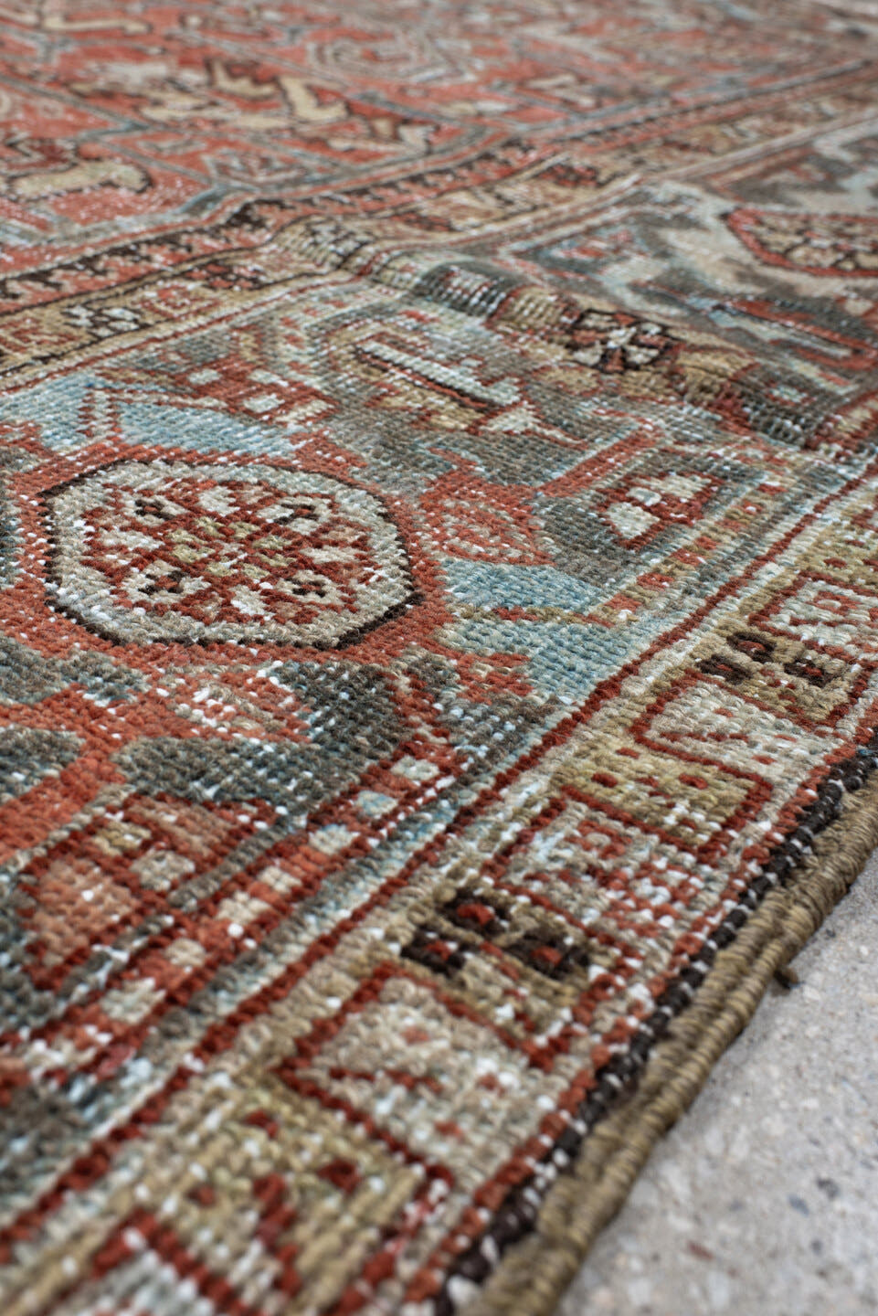 7' x 9' one-of-a-kind handmade antique Heriz large size rug. Color palette: terra cotta, ivory, slate, charcoal, rust, camel