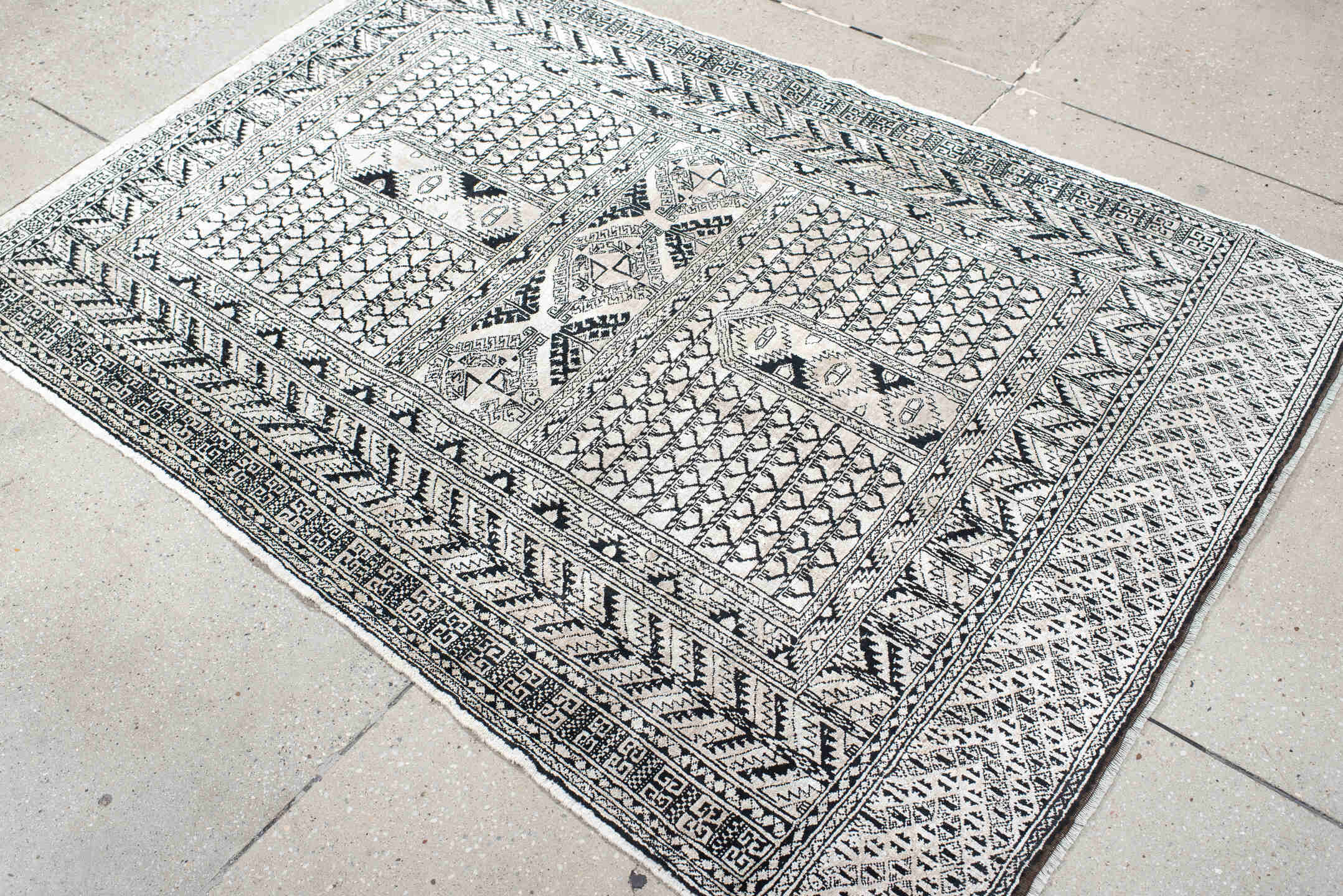 3' x 5' one-of-a-kind handmade vintage Afghan small size rug. Color palette: ivory, charcoal, black, gray