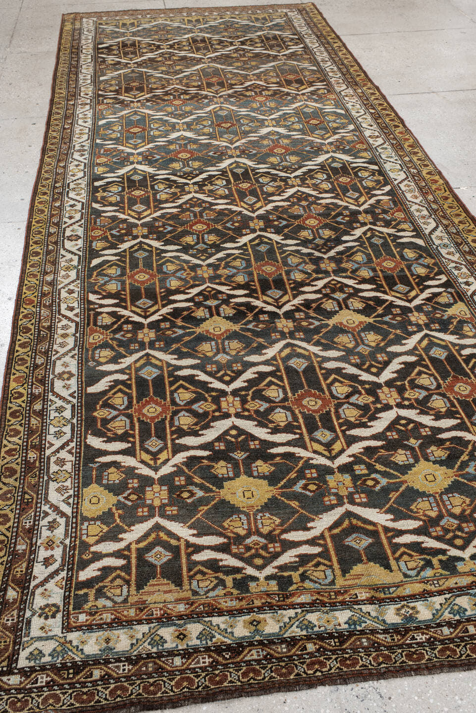 5' x 14' one-of-a-kind handmade antique Baktiary rug. Color palette: brown, ivory, camel, slate, rust, gold, charcoal