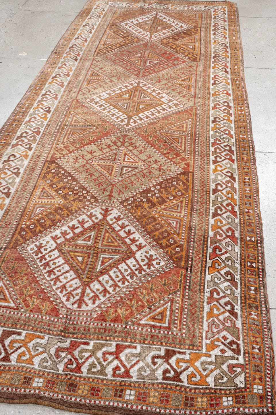 4' x 12' one-of-a-kind handmade antique Anatolian runner rug. Color palette: ivory, rust, camel, brown, terra cotta, taupe
