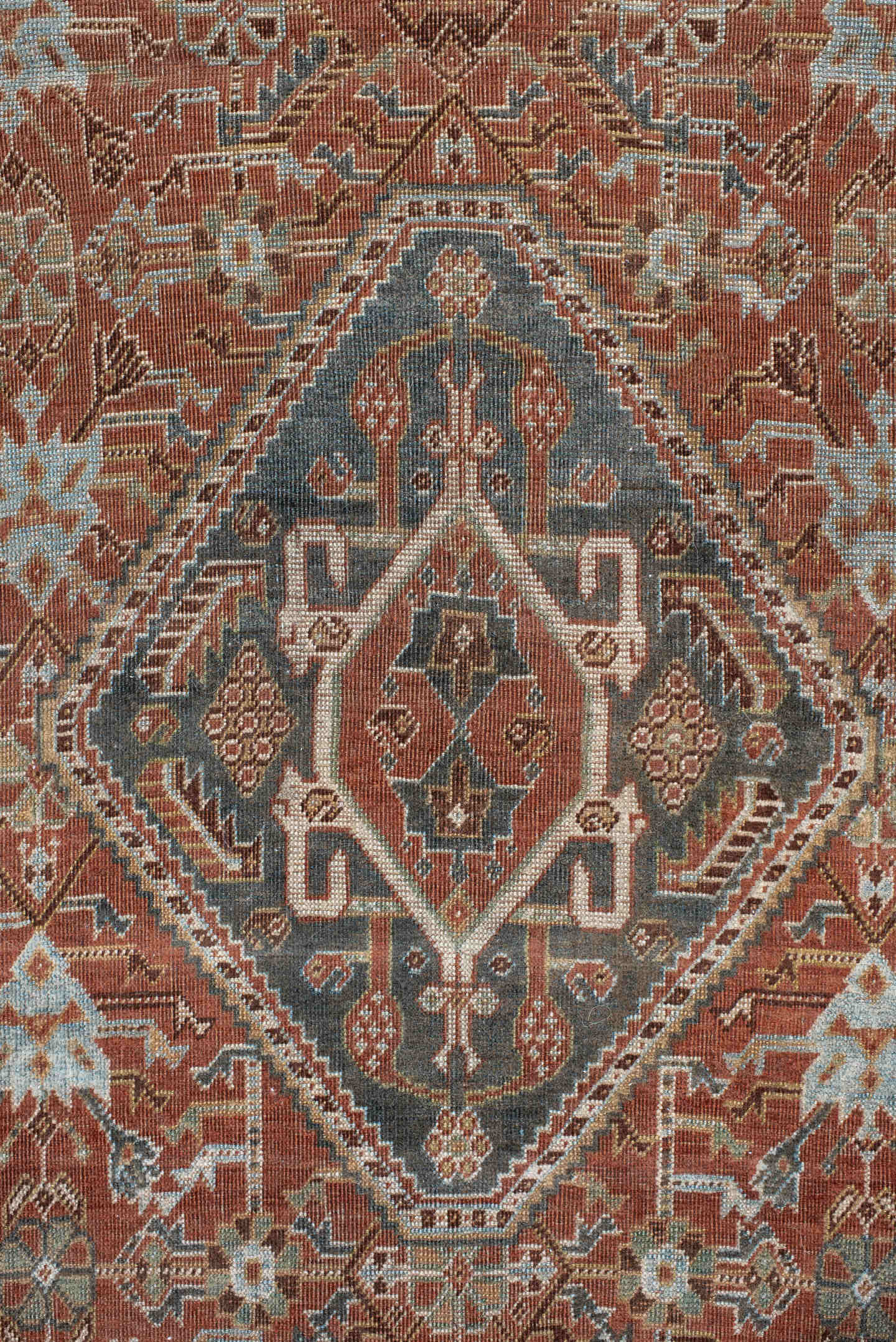 4' x 7' one-of-a-kind handmade vintage Qashqai rug. Color palette: terra cotta, pale blue, ivory, dark brown, slate, taupe