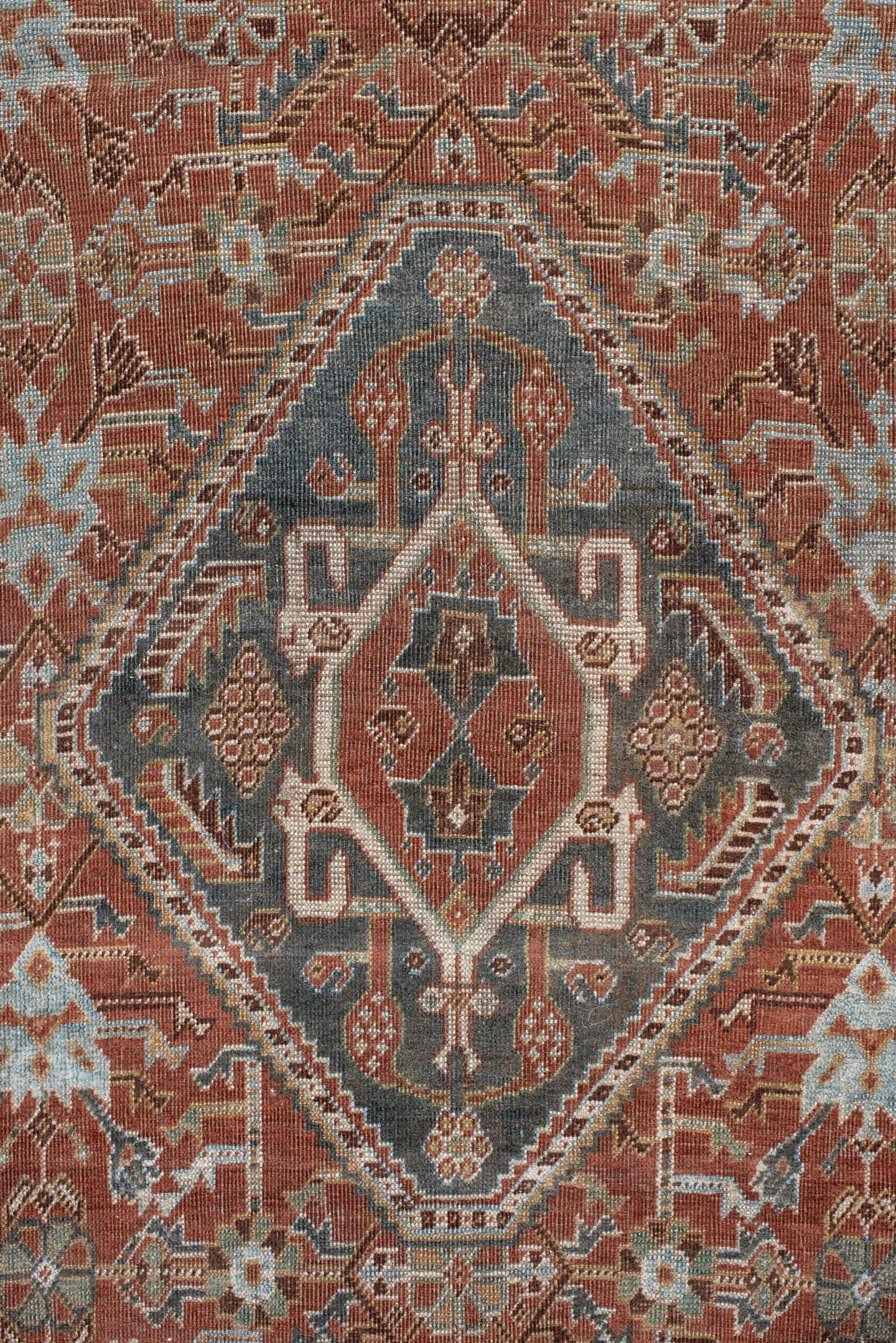 4' x 7' one-of-a-kind handmade vintage Qashqai rug. Color palette: terra cotta, pale blue, ivory, dark brown, slate, taupe