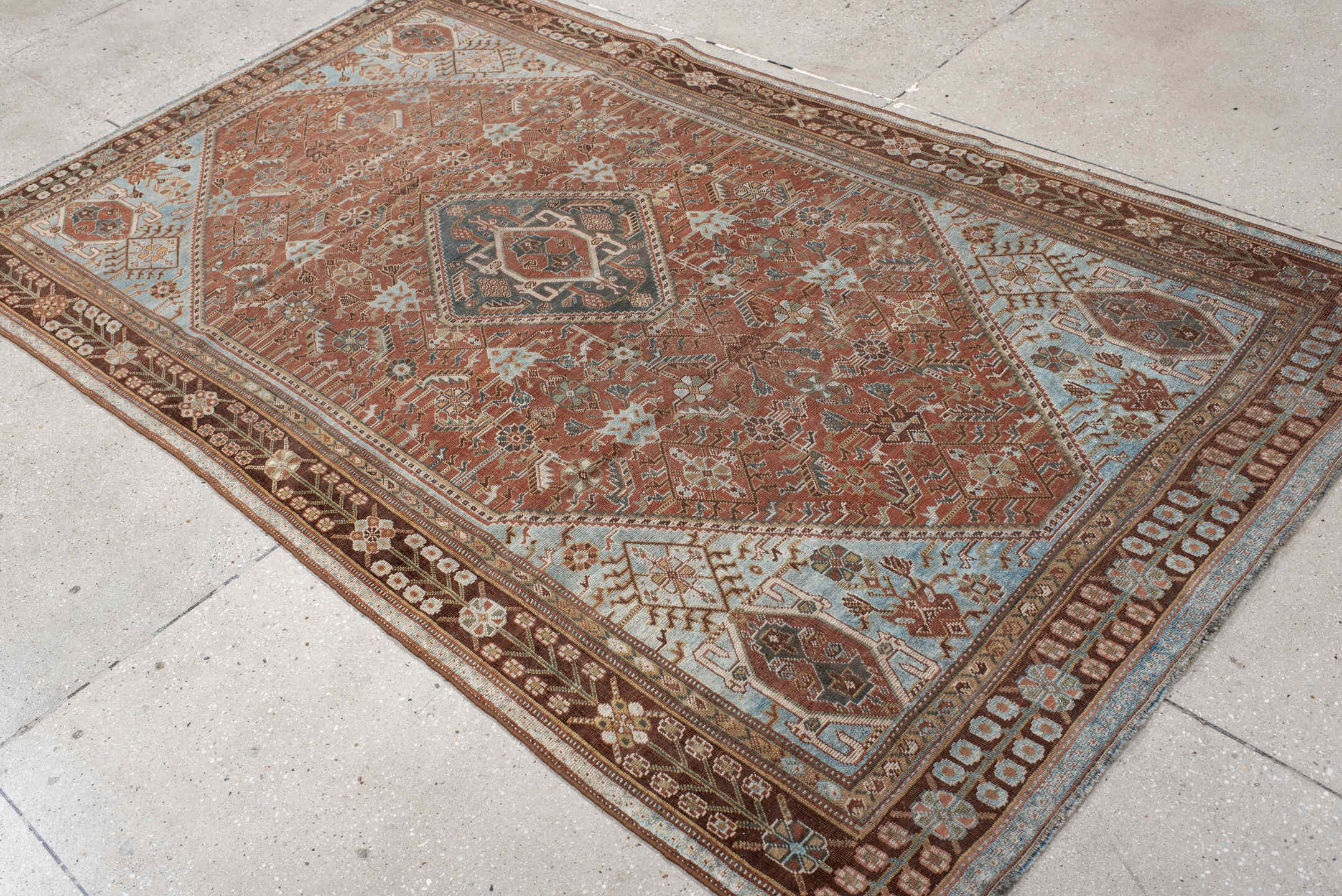 4' x 7' one-of-a-kind handmade vintage Qashqai rug. Color palette: terra cotta, pale blue, ivory, dark brown, slate, taupe