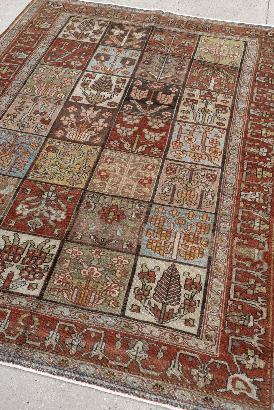 5' x 7' one-of-a-kind handmade antique Baktiary rug. Color palette: rust, ivory, brown, sky blue, sage, taupe, camel