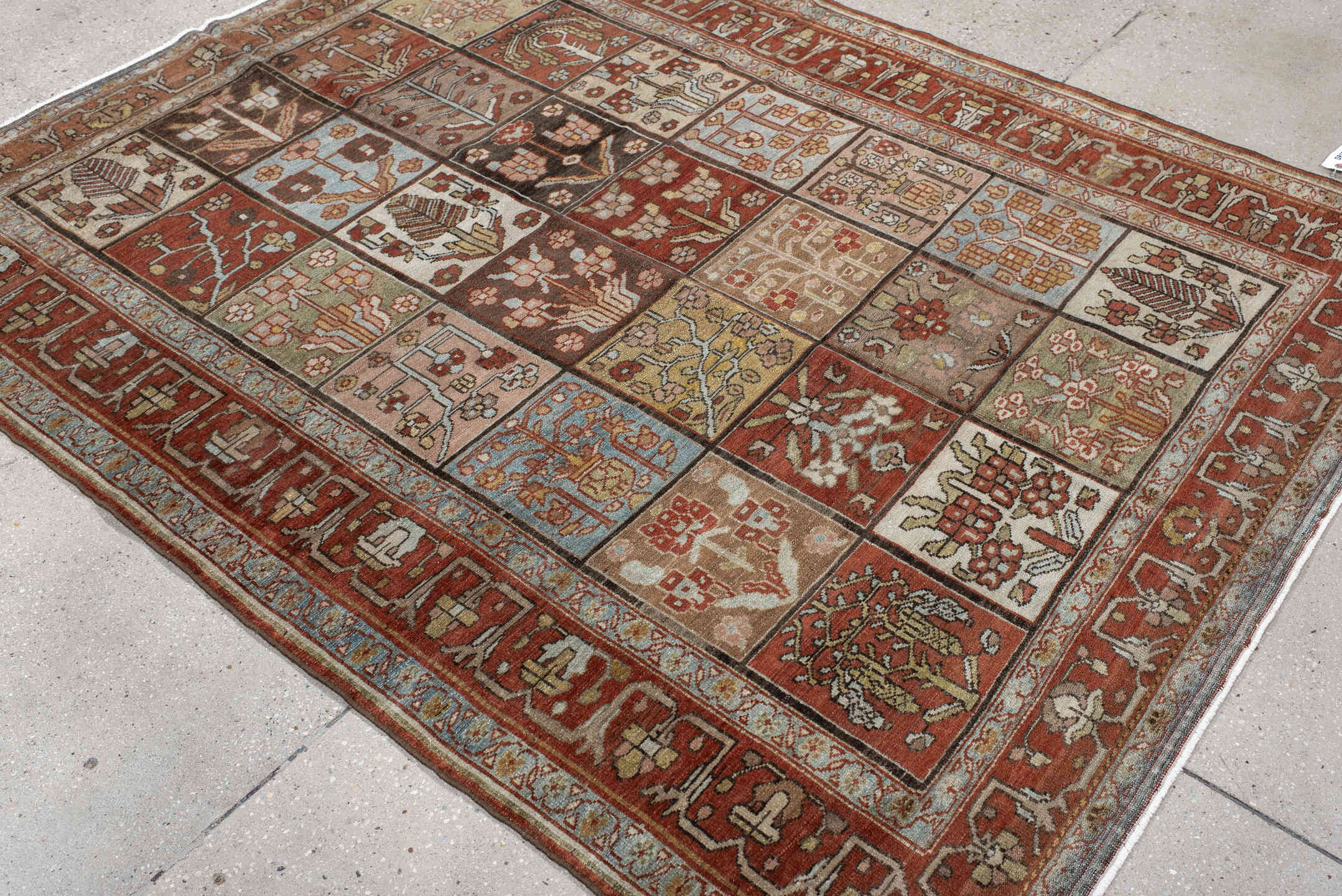 5' x 7' one-of-a-kind handmade antique Baktiary rug. Color palette: rust, ivory, brown, sky blue, sage, taupe, camel
