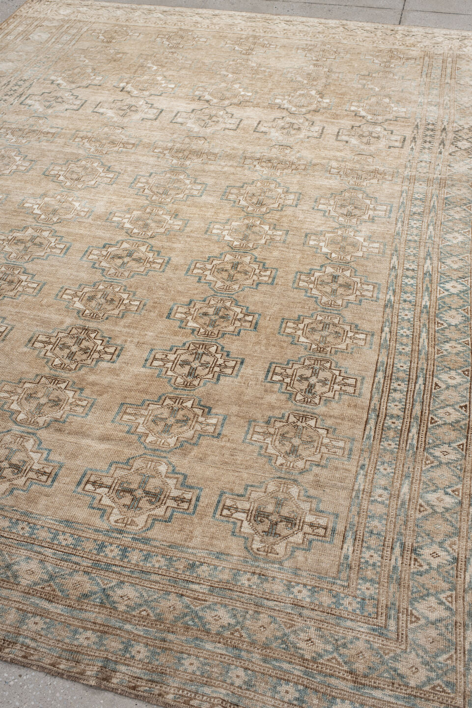 7' x 9' one-of-a-kind handmade antique Afghan rug. Color palette: ivory, taupe, pale blue, beige, camel, light brown, gray