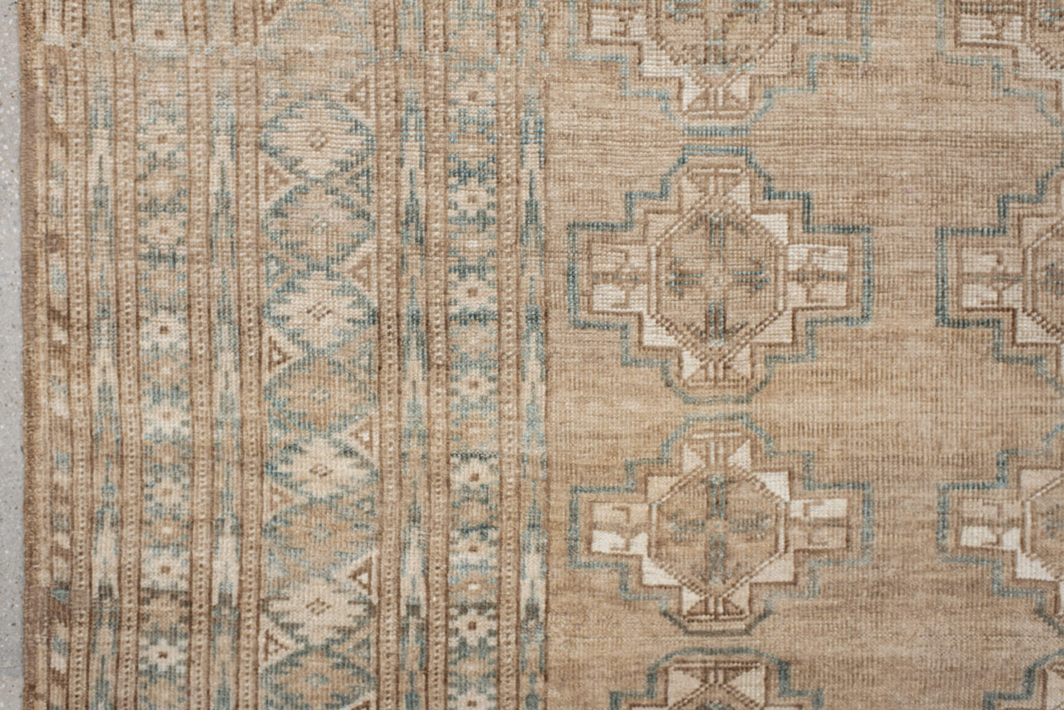7' x 9' one-of-a-kind handmade antique Afghan rug. Color palette: ivory, taupe, pale blue, beige, camel, light brown, gray