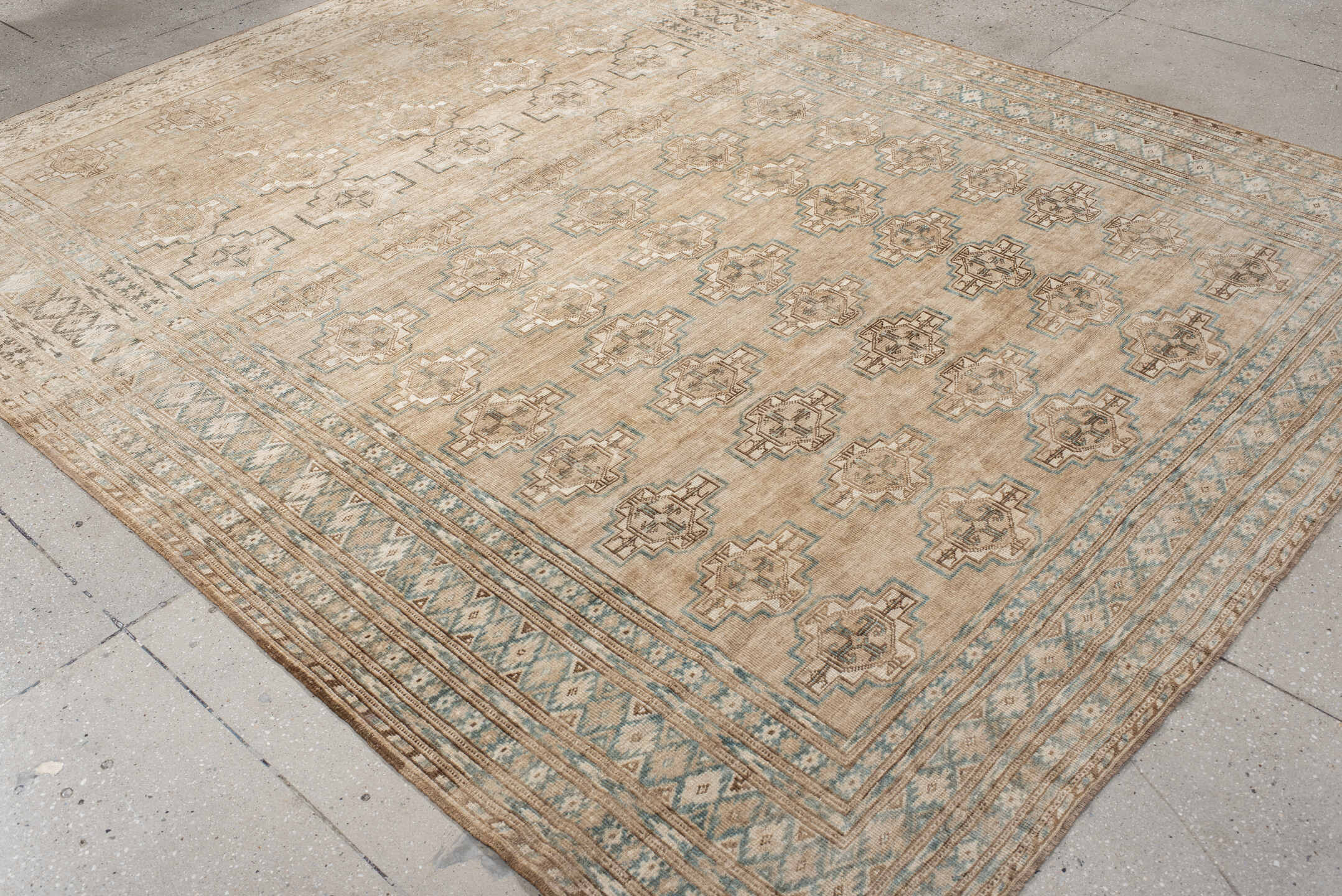 7' x 9' one-of-a-kind handmade antique Afghan rug. Color palette: ivory, taupe, pale blue, beige, camel, light brown, gray
