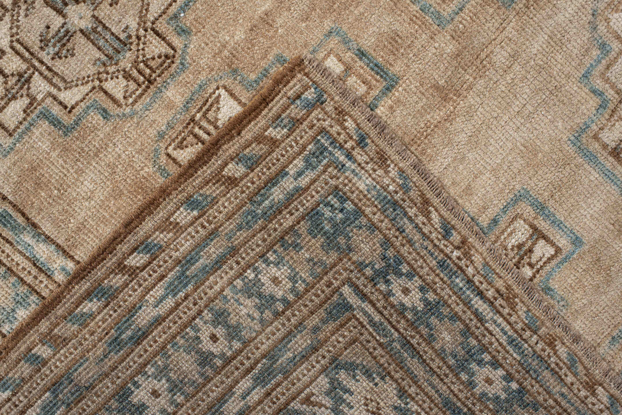 7' x 9' one-of-a-kind handmade antique Afghan rug. Color palette: ivory, taupe, pale blue, beige, camel, light brown, gray