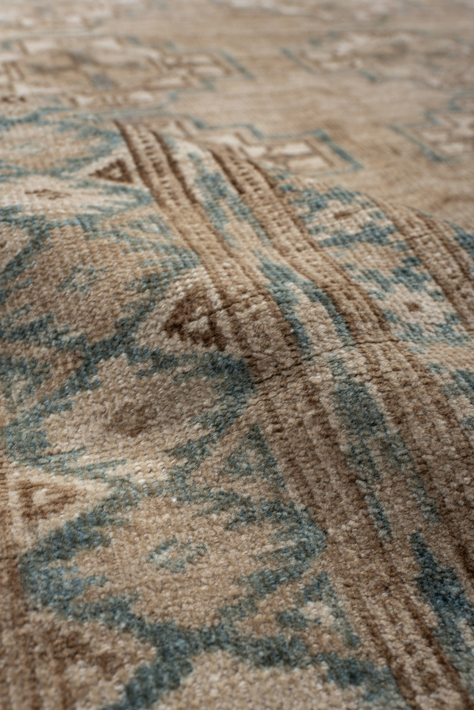 7' x 9' one-of-a-kind handmade antique Afghan rug. Color palette: ivory, taupe, pale blue, beige, camel, light brown, gray