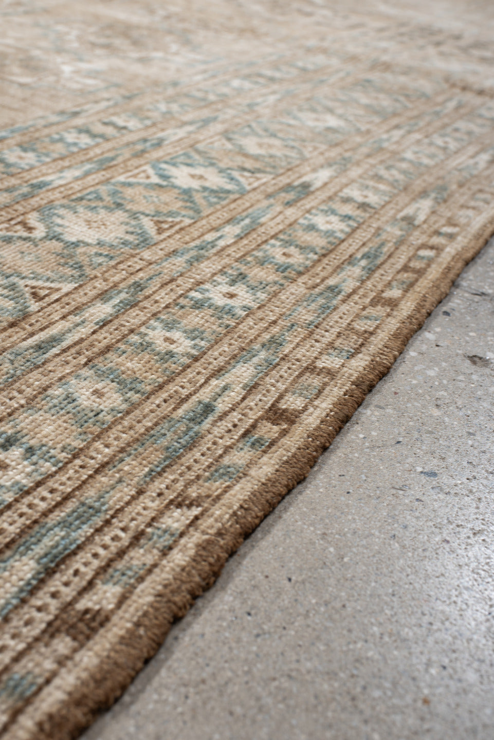 7' x 9' one-of-a-kind handmade antique Afghan rug. Color palette: ivory, taupe, pale blue, beige, camel, light brown, gray